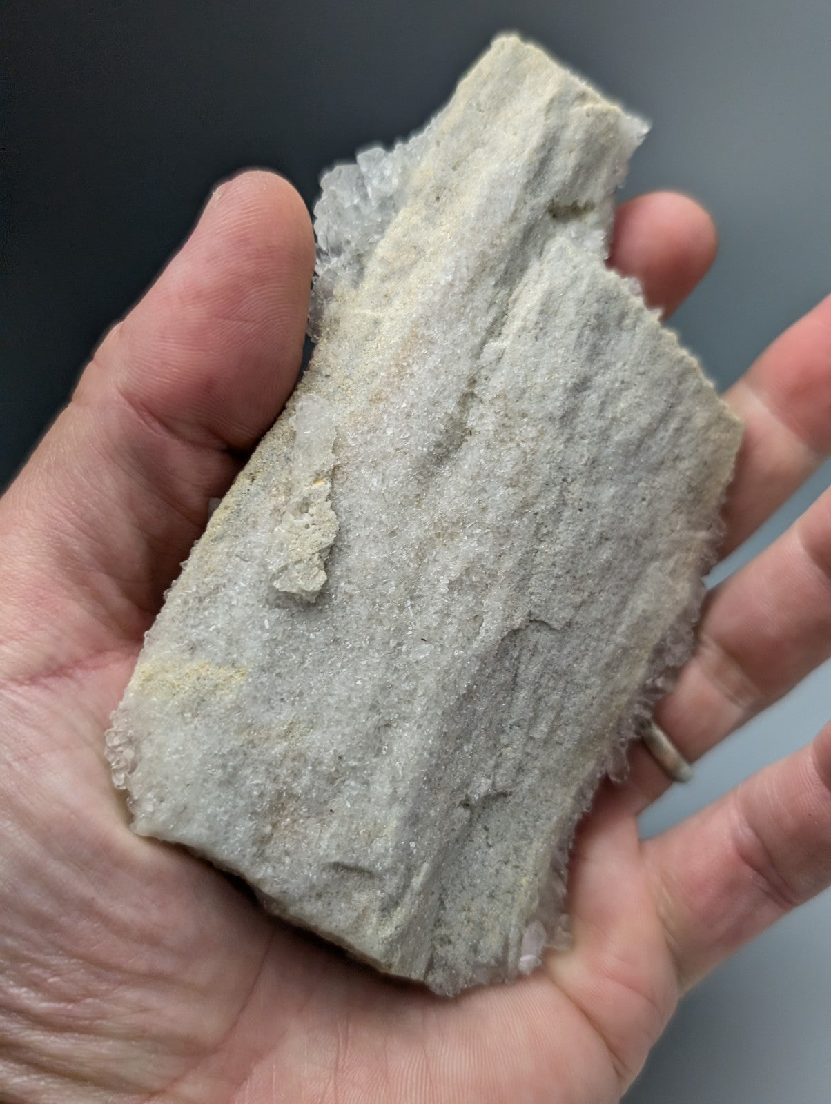 A very rare brookite on quartz stone fragment with a rough light gray textured surface from miller mountain arkansas usa