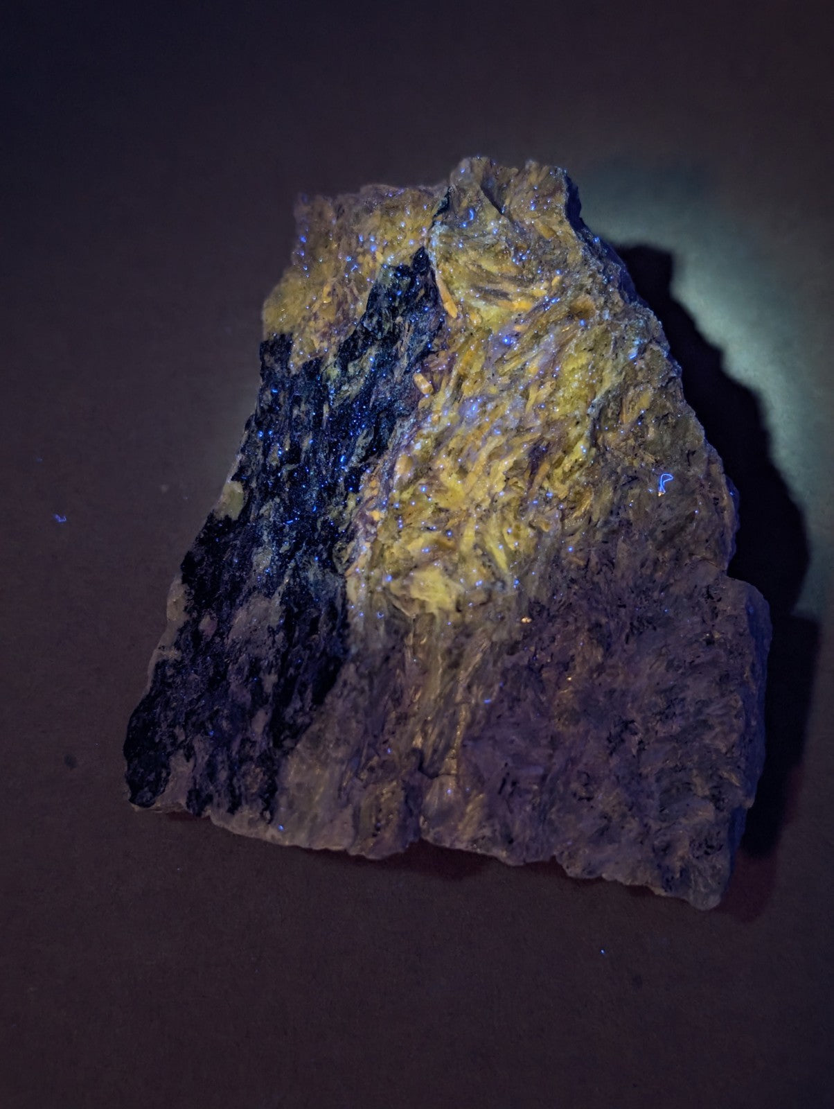 A rugged miserite and wollastonite mineral with deep black and golden-yellow patches from Arkansas, USA