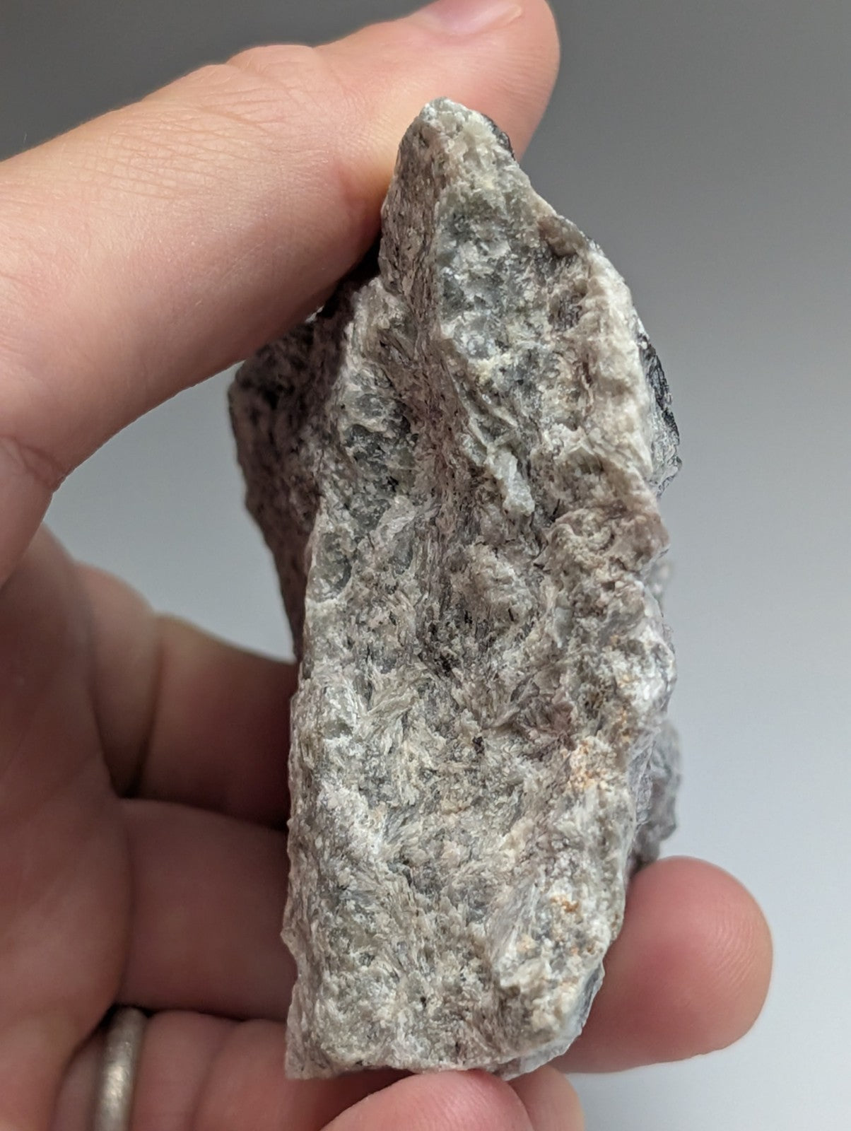 A very rare miserite and wollastonite mineral specimen from wilson springs arkansas with gray speckled texture and dark veins