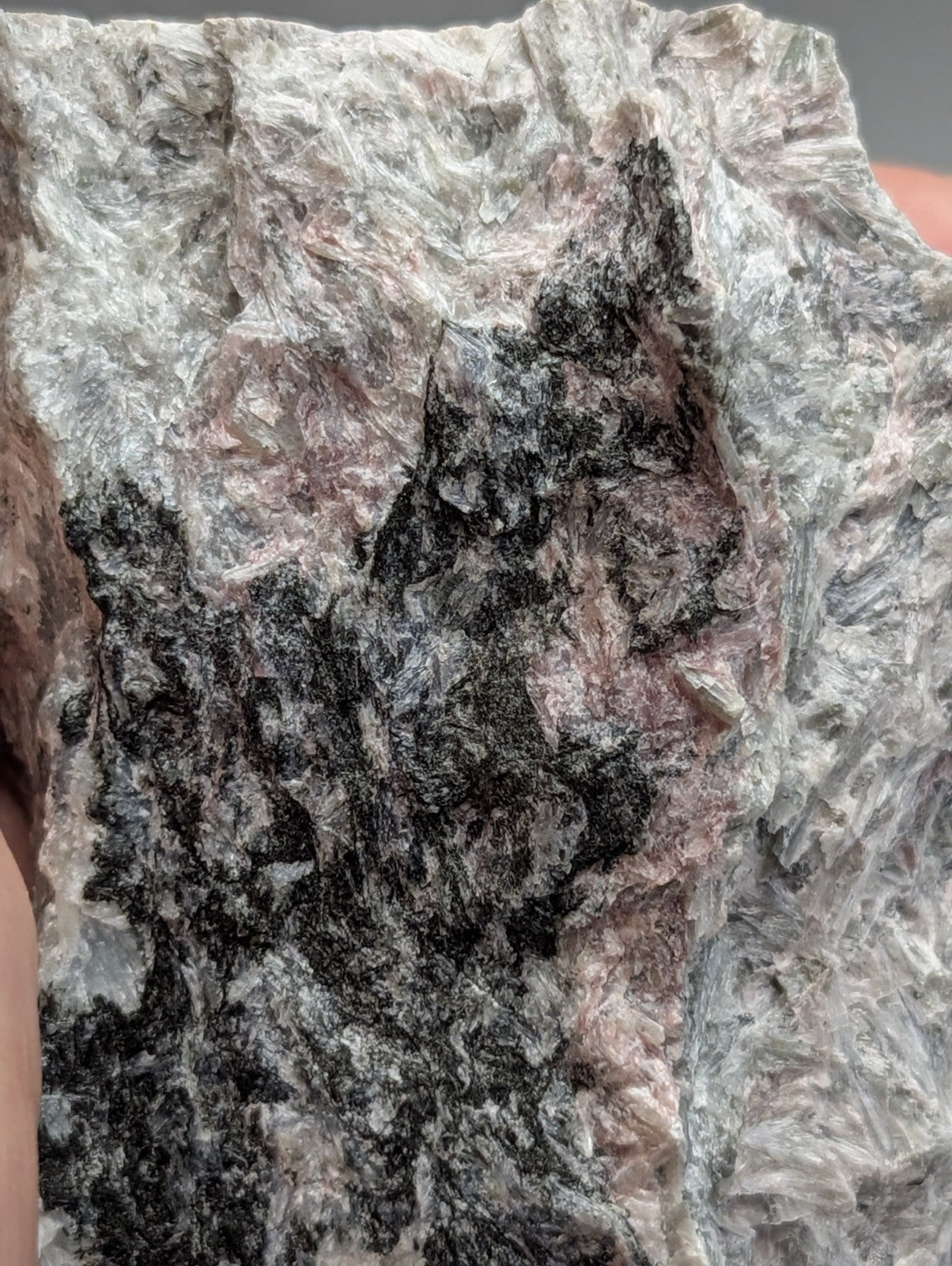 Very rare miserite and wollastonite mineral specimen with textured gray black and pinkish swirling patterns from arkansas