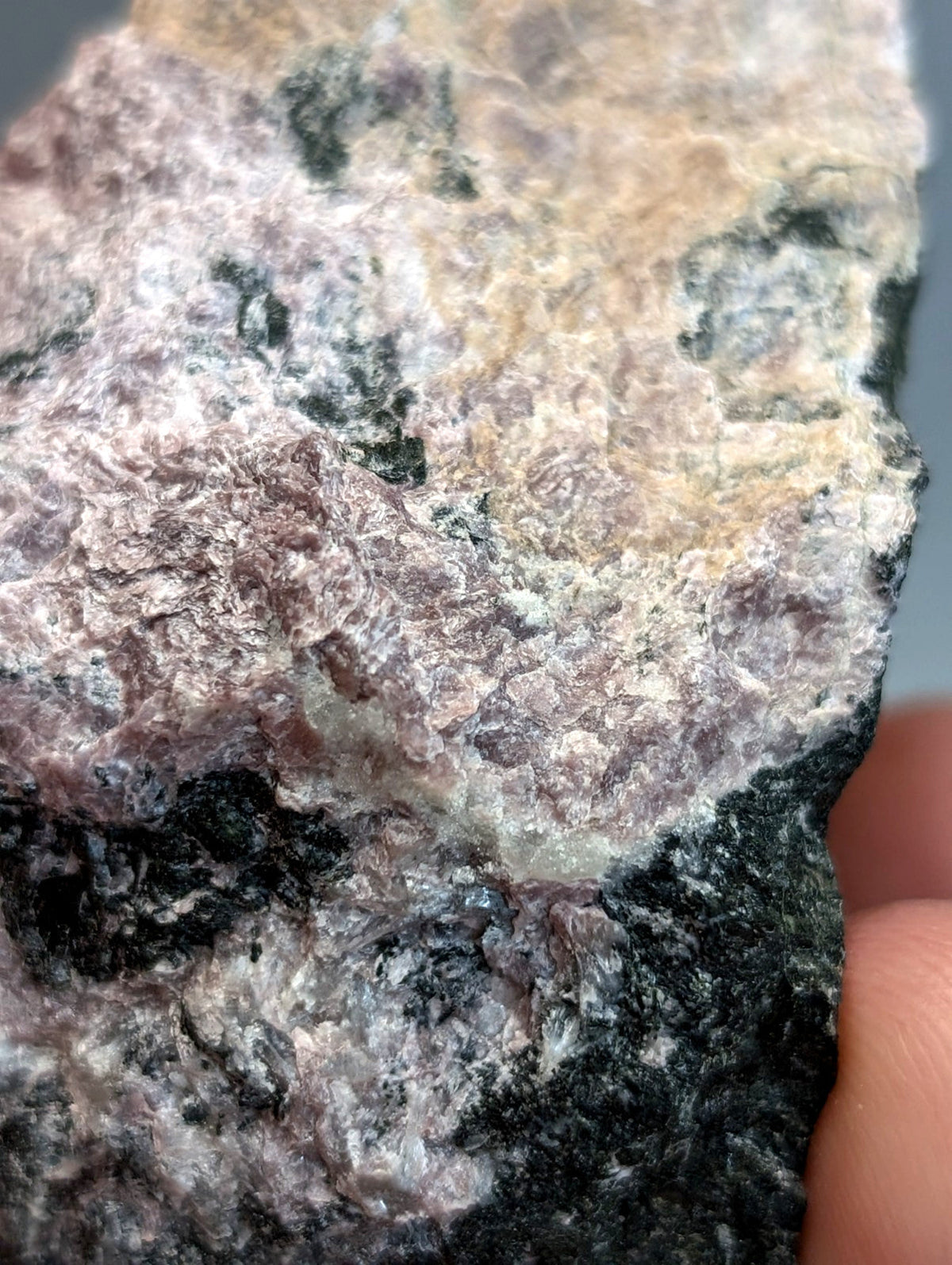 A rugged multicolored miserite and wollastonite rock with pinkish purple beige and dark green patches from arkansas usa