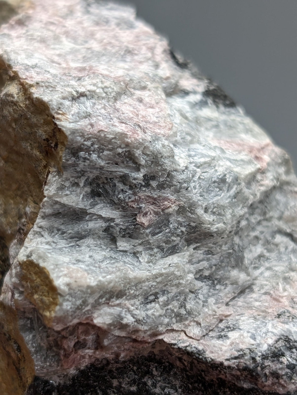 Very rare miserite and wollastonite rock from wilson springs showing a mottled gray white and pinkish surface
