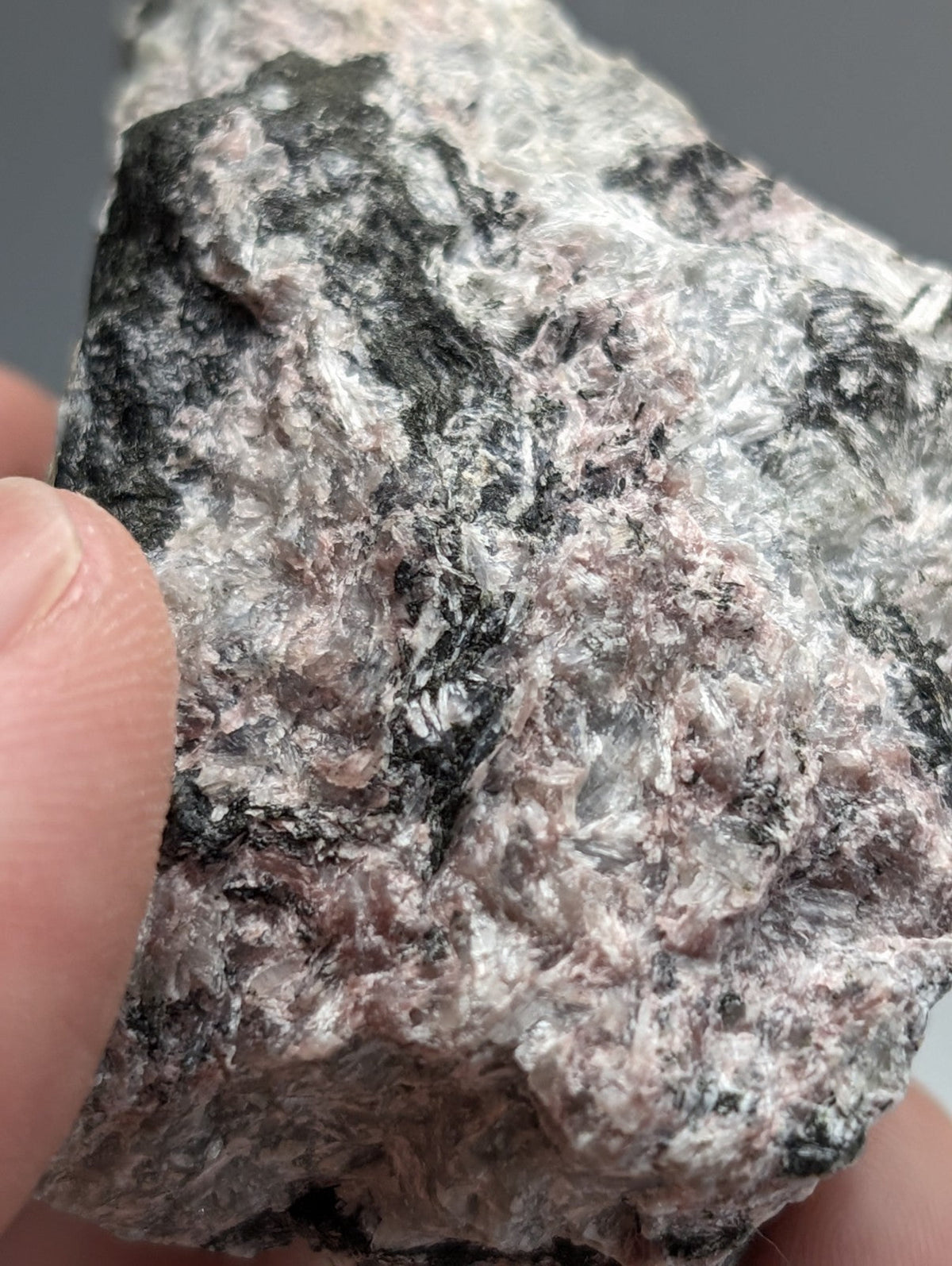 Very rare miserite and wollastonite mineral specimen with rough pink and black textured surface from Arkansas USA