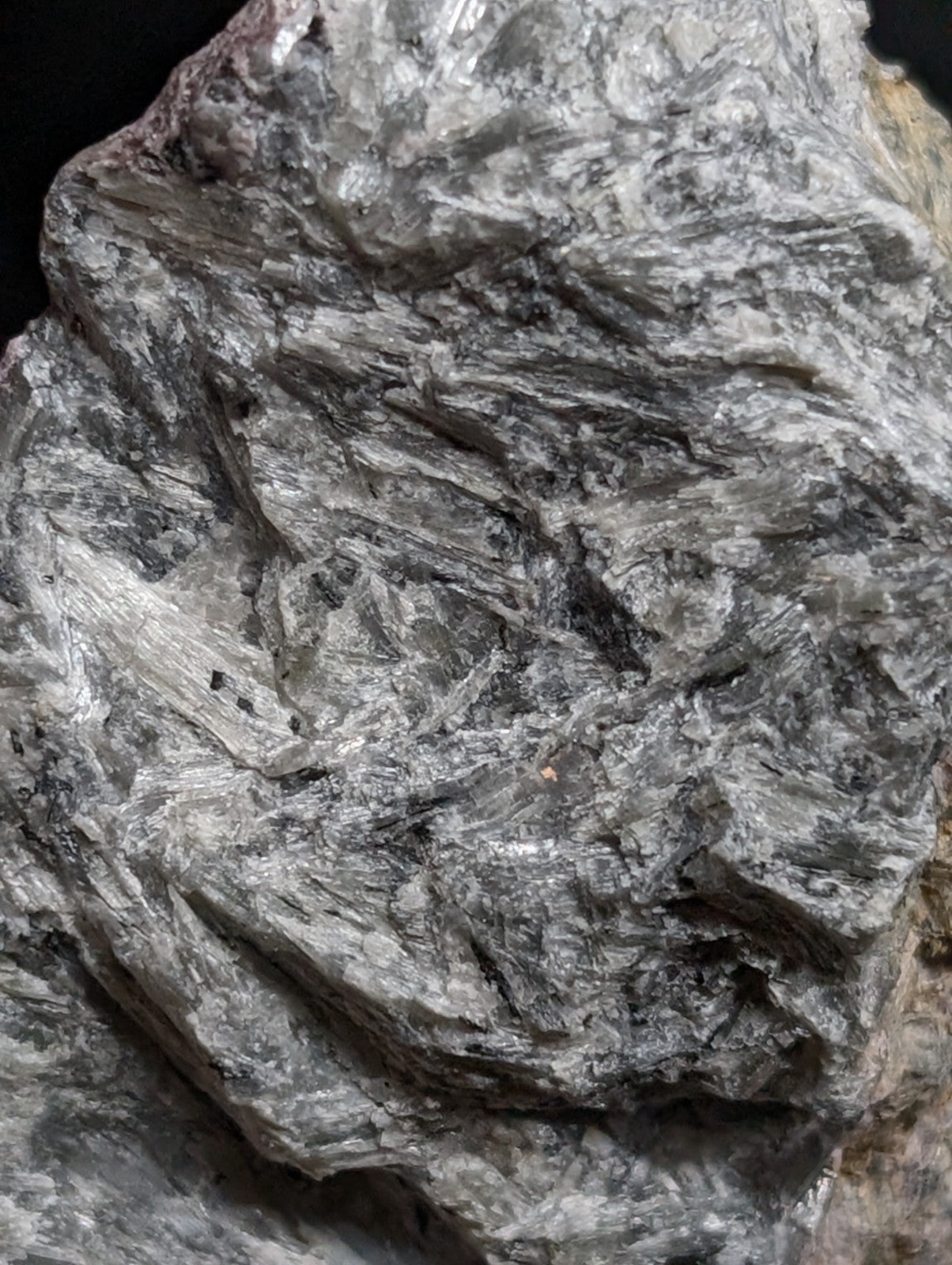 A rough, grayish mineral specimen with a crystalline texture and subtle metallic sheen.
