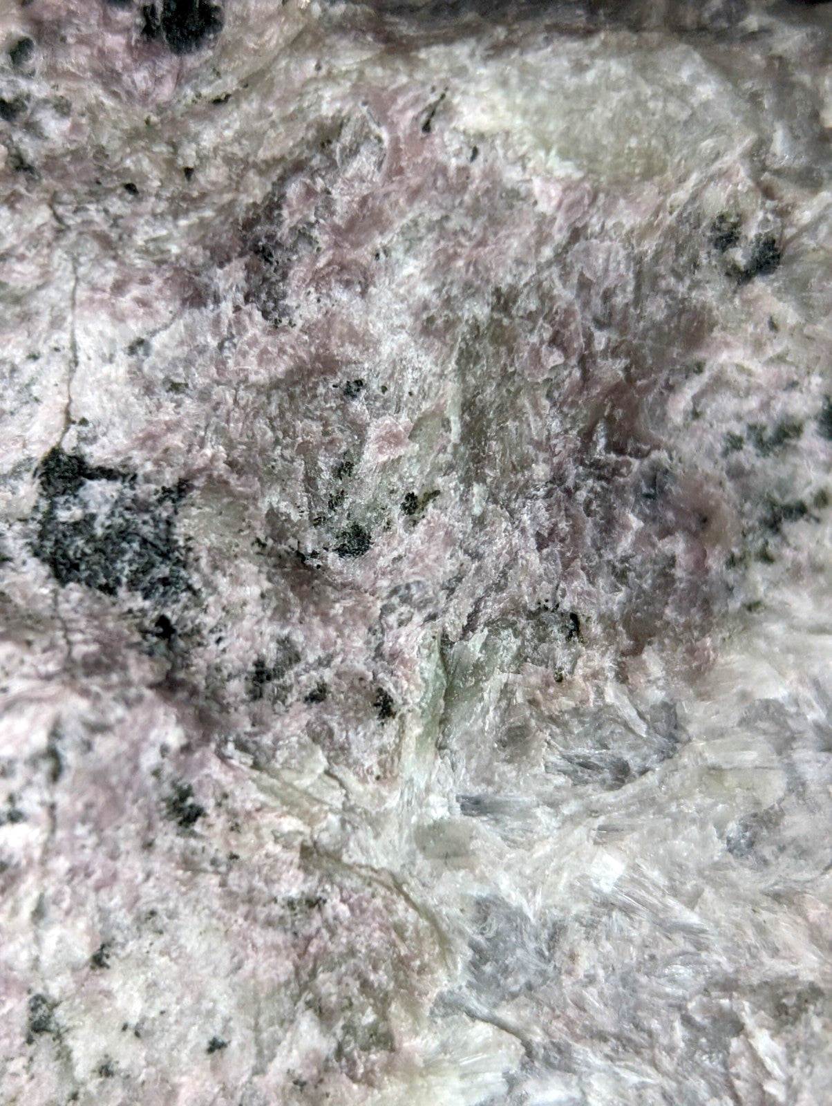 Pink and gray speckled granite stone surface.