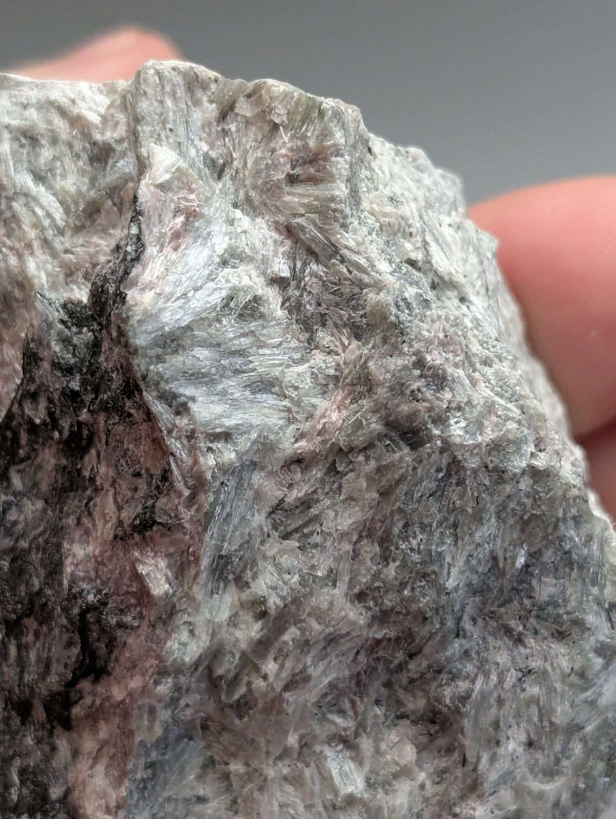 Very rare miserite and wollastonite mineral specimen with rough grayish white crystalline textures and subtle pink hues