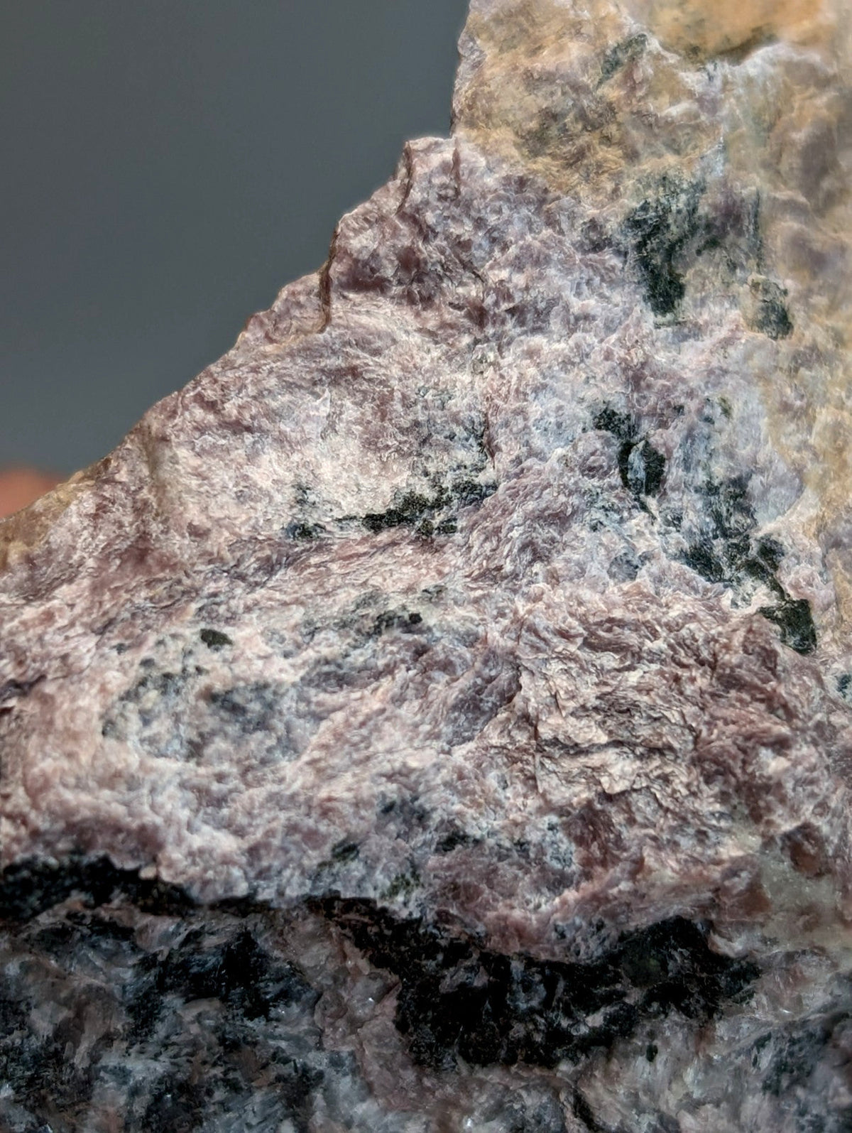 A rugged very rare miserite and wollastonite rock from wilson springs with gray pinkish brown and dark green mineral patches