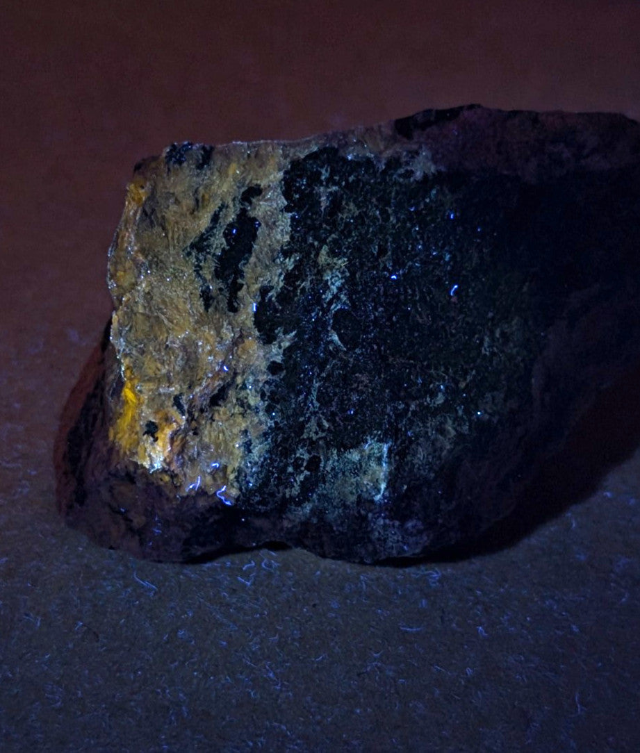 Very rare miserite and wollastonite rock from wilson springs arkansas with dark surface and gold metallic patches