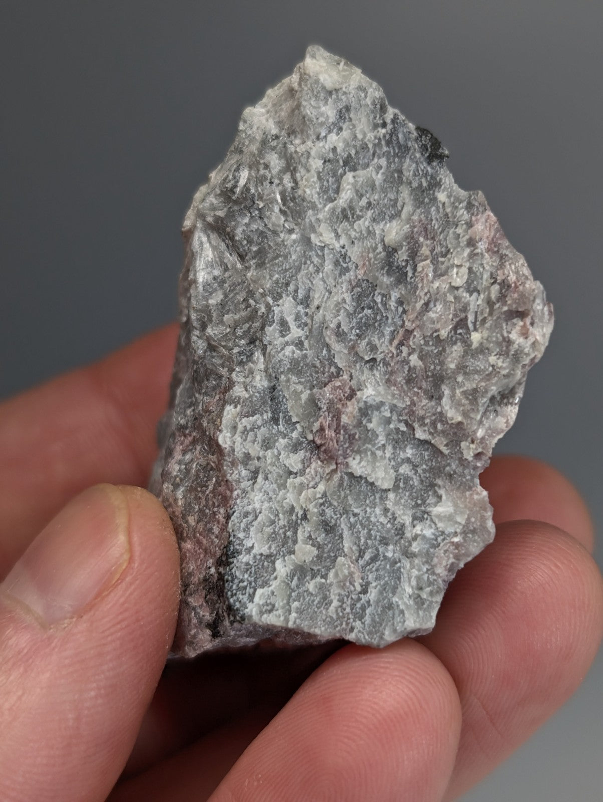 A rough irregular miserite and wollastonite rock with gray white and pink hues from wilson springs arkansas usa