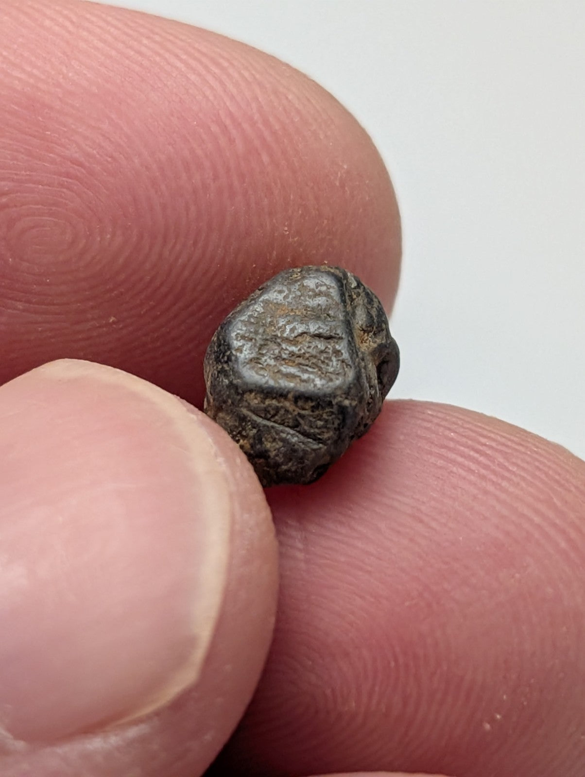 A very rare set of 25 small dark gray irregular ancient coins with visible engraved markings and worn surfaces