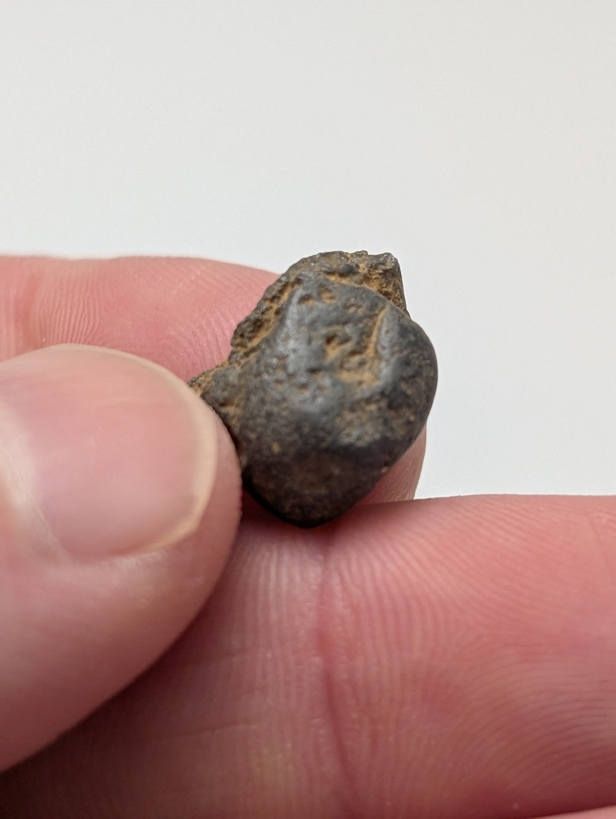 A weathered dark gray metallic placer rutile with rough texture and faint engravings from magnet cove arkansas set of 25