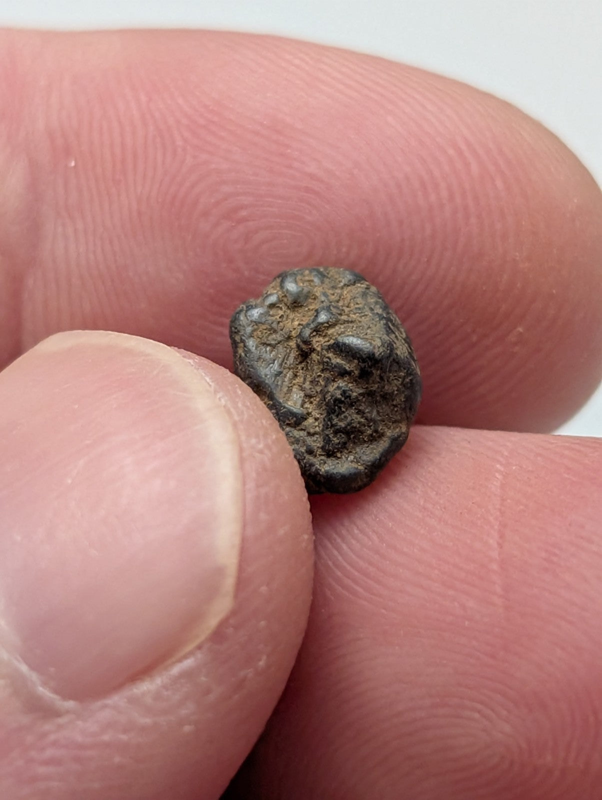 A small dark gray metallic placer rutile with rough surface and wear from magnet cove arkansas set of 25
