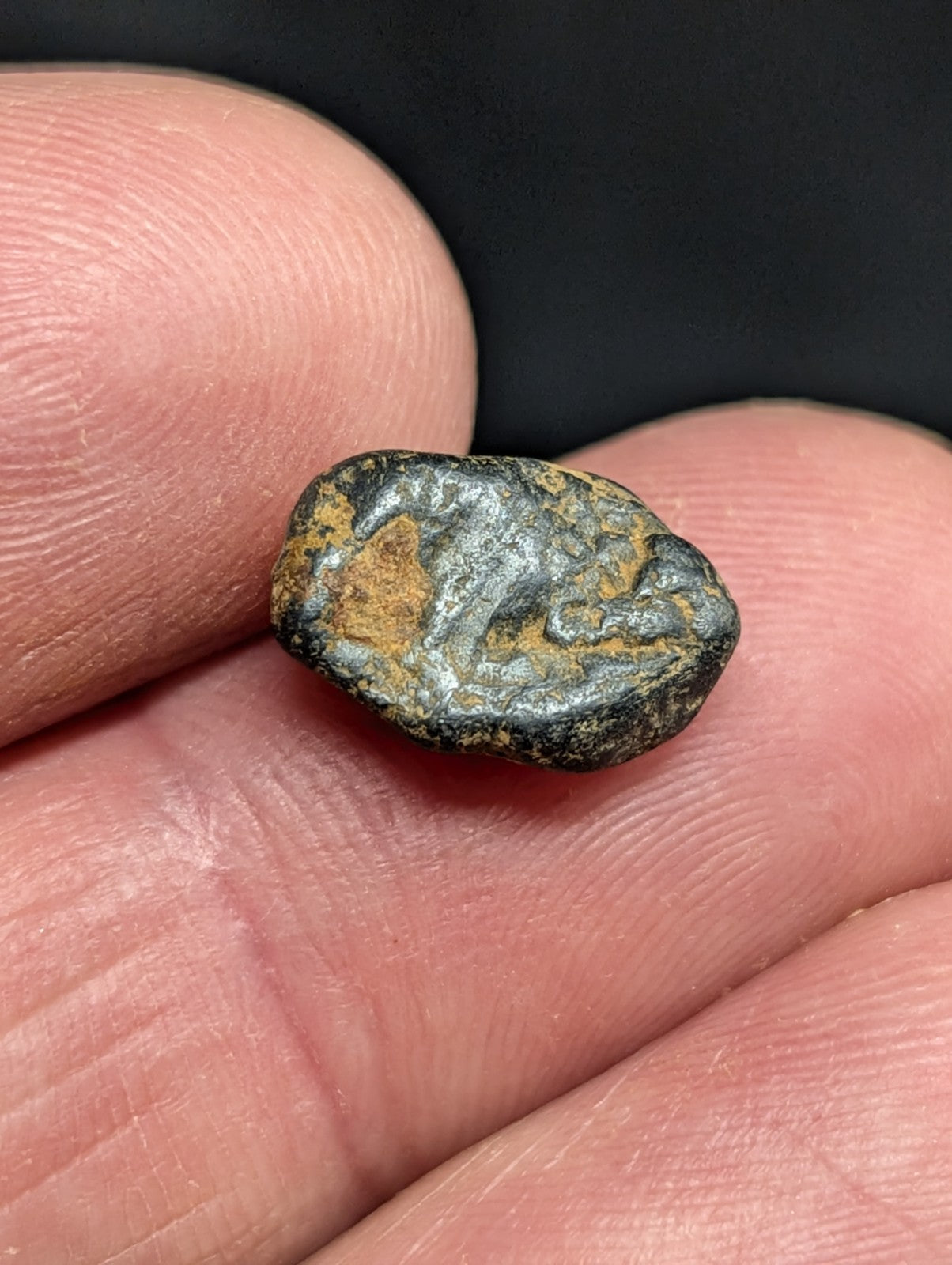 Antique bronze coin with a weathered, dark green patina and patches of orange oxidation.