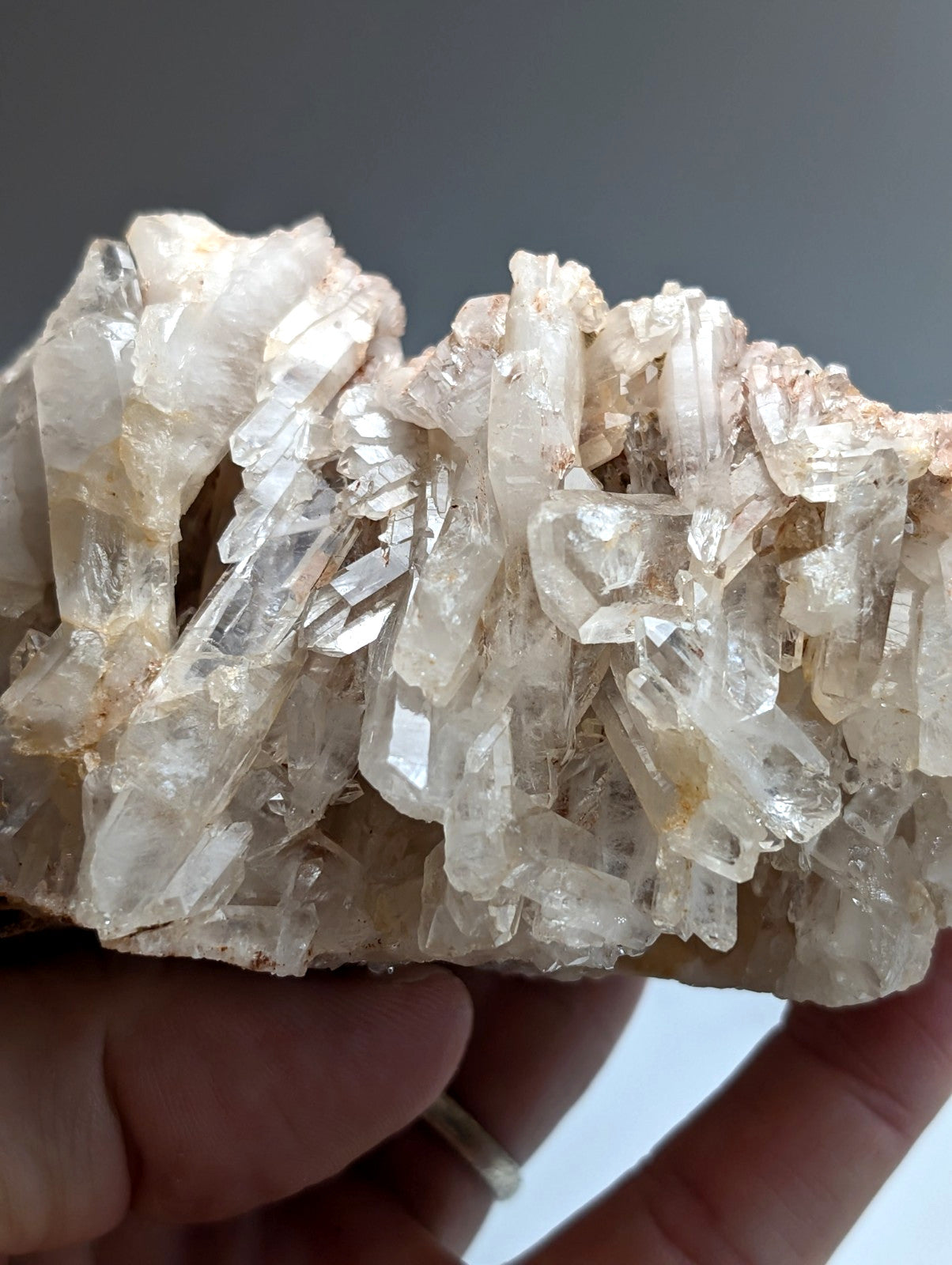 A cluster of translucent clear quartz crystals with golden and brownish hues very unique faden quartz from arkansas