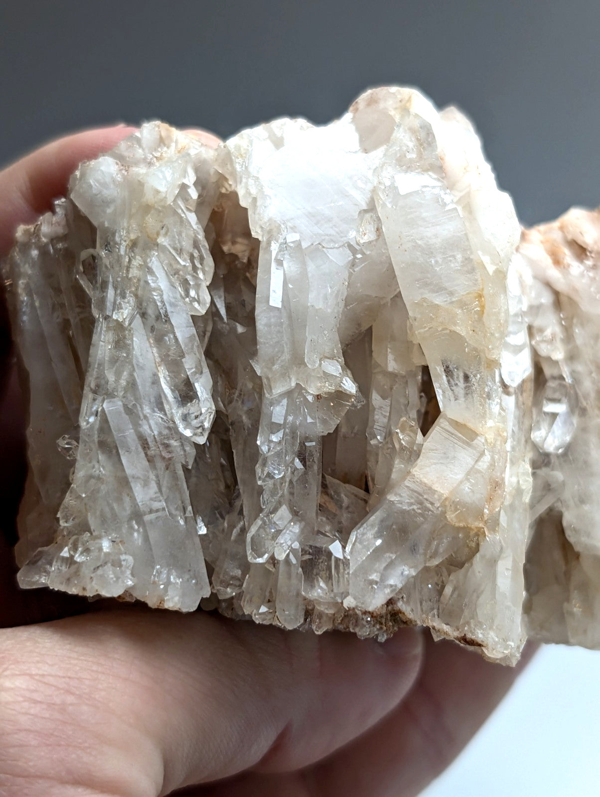 A cluster of translucent faden quartz crystals with clear faceted points and subtle golden hues from Arkansas usa