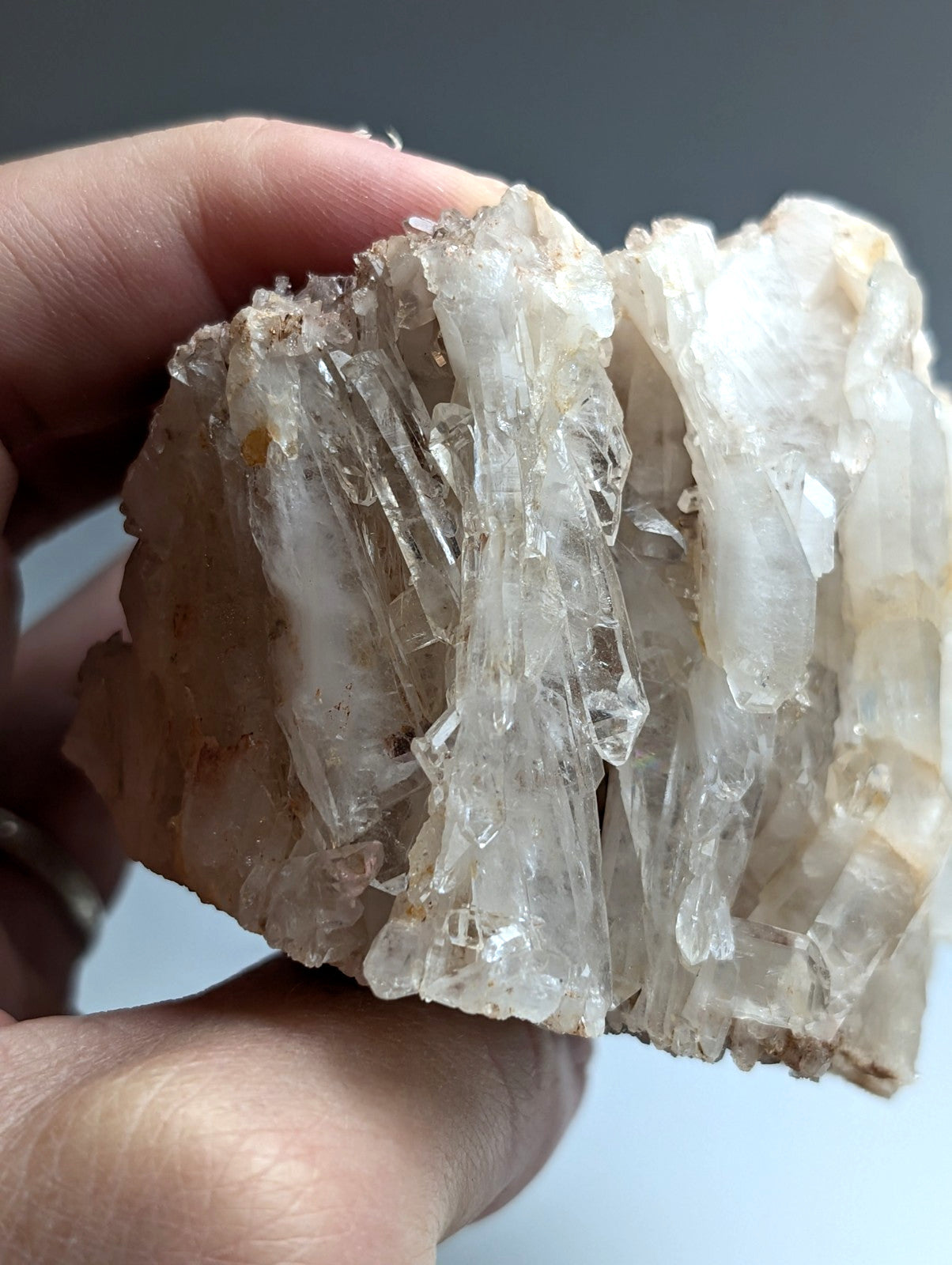 A cluster of translucent faden quartz crystals with clear faceted points on a rough matrix from Arkansas usa