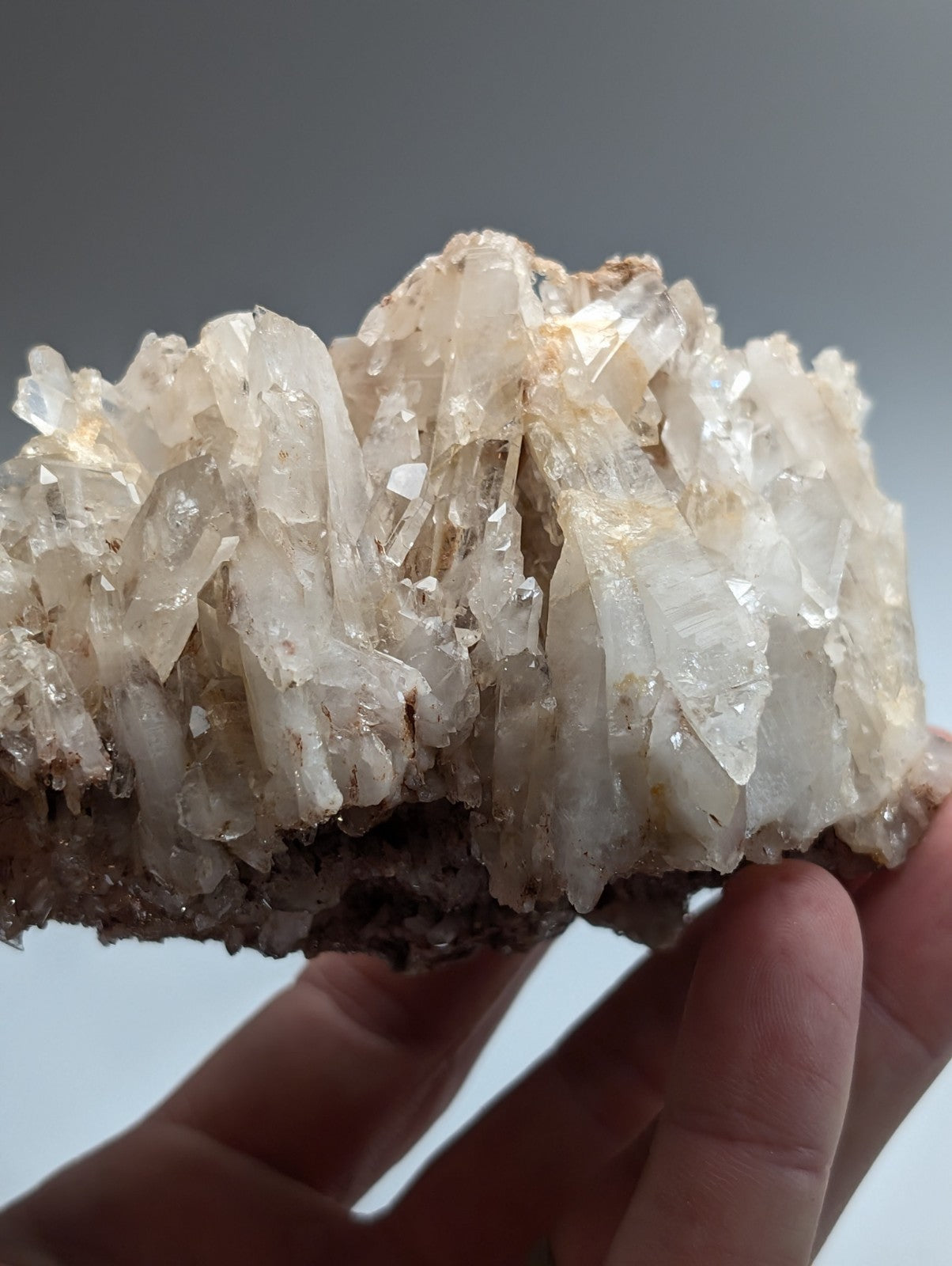 A cluster of translucent pale white and faintly golden faden quartz crystal formations from montgomery county arkansas usa