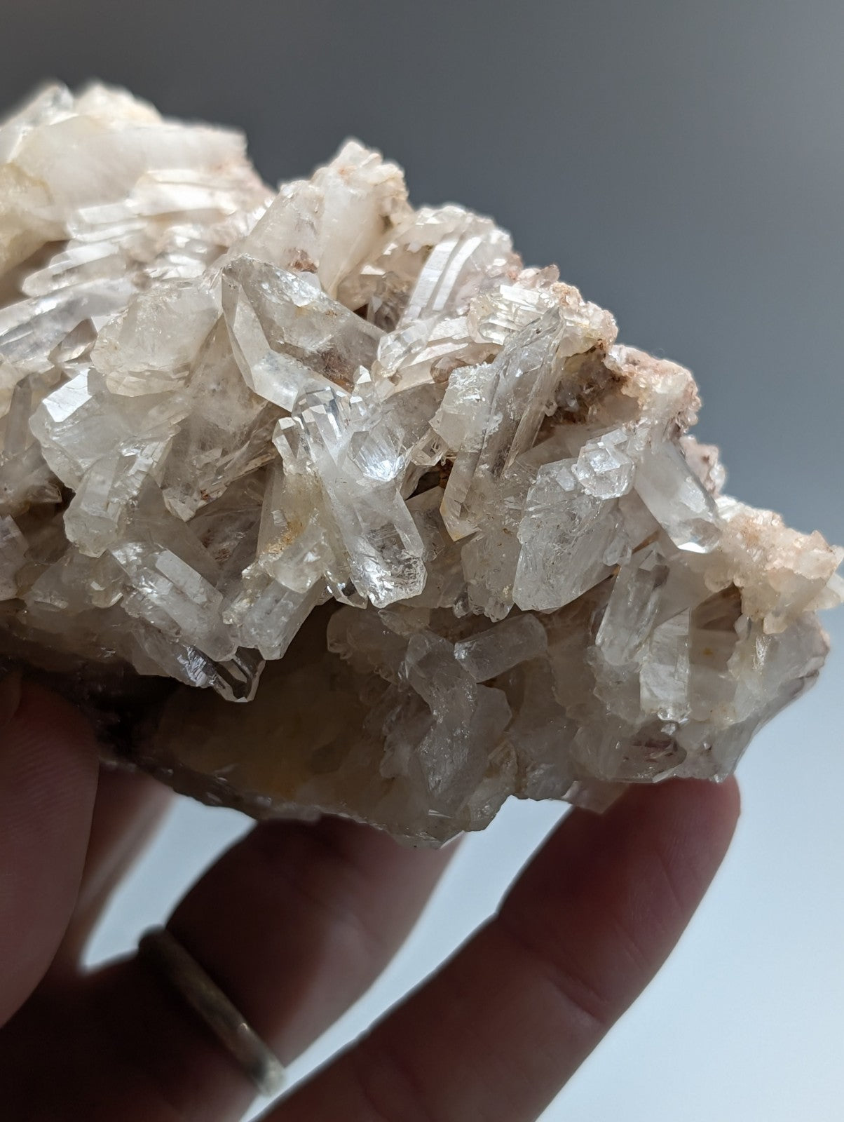 A cluster of translucent pale milky-white faden quartz crystal formations with sharp angular facets from montgomery county arkansas