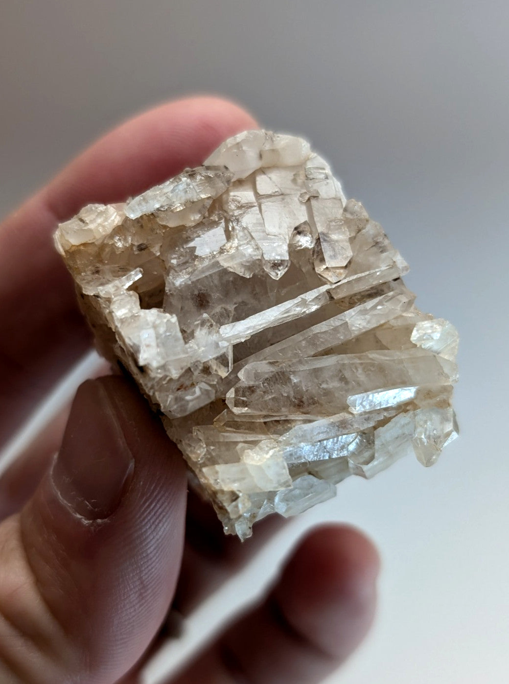 A translucent pale quartz crystal cluster with sharp interlocking facets from montgomery county arkansas usa