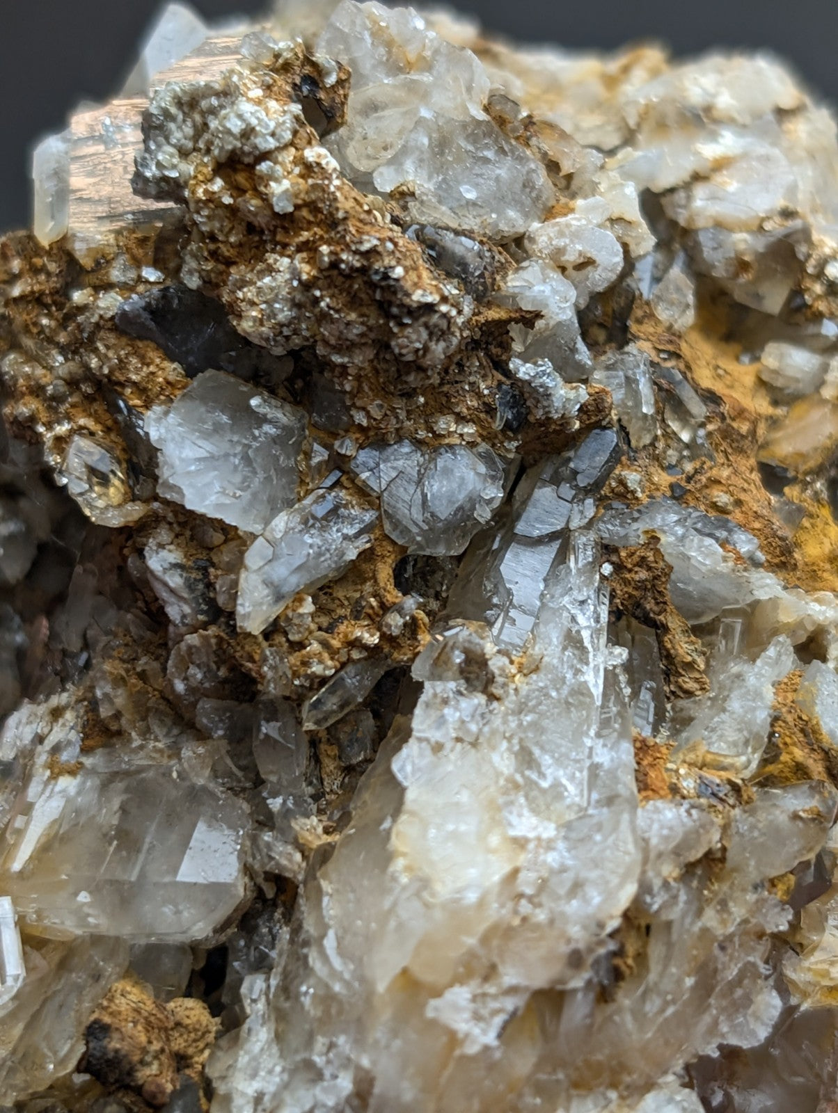 A cluster of translucent quartz with brown and metallic silver cookeite mineral deposits from saline county Arkansas