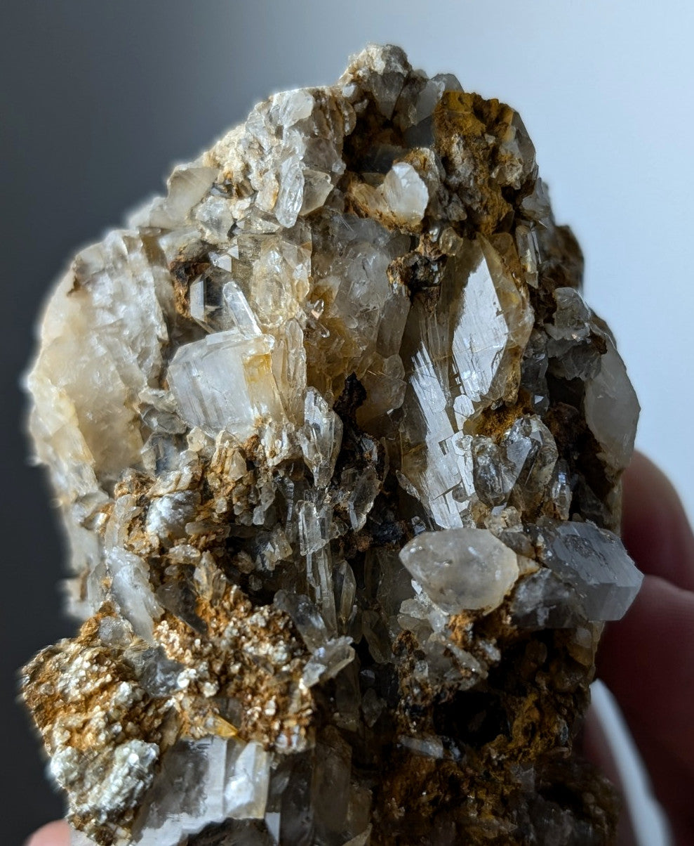 A cluster of translucent quartz crystals with golden yellow cookeite inclusions from saline county Arkansas rare conglomerate