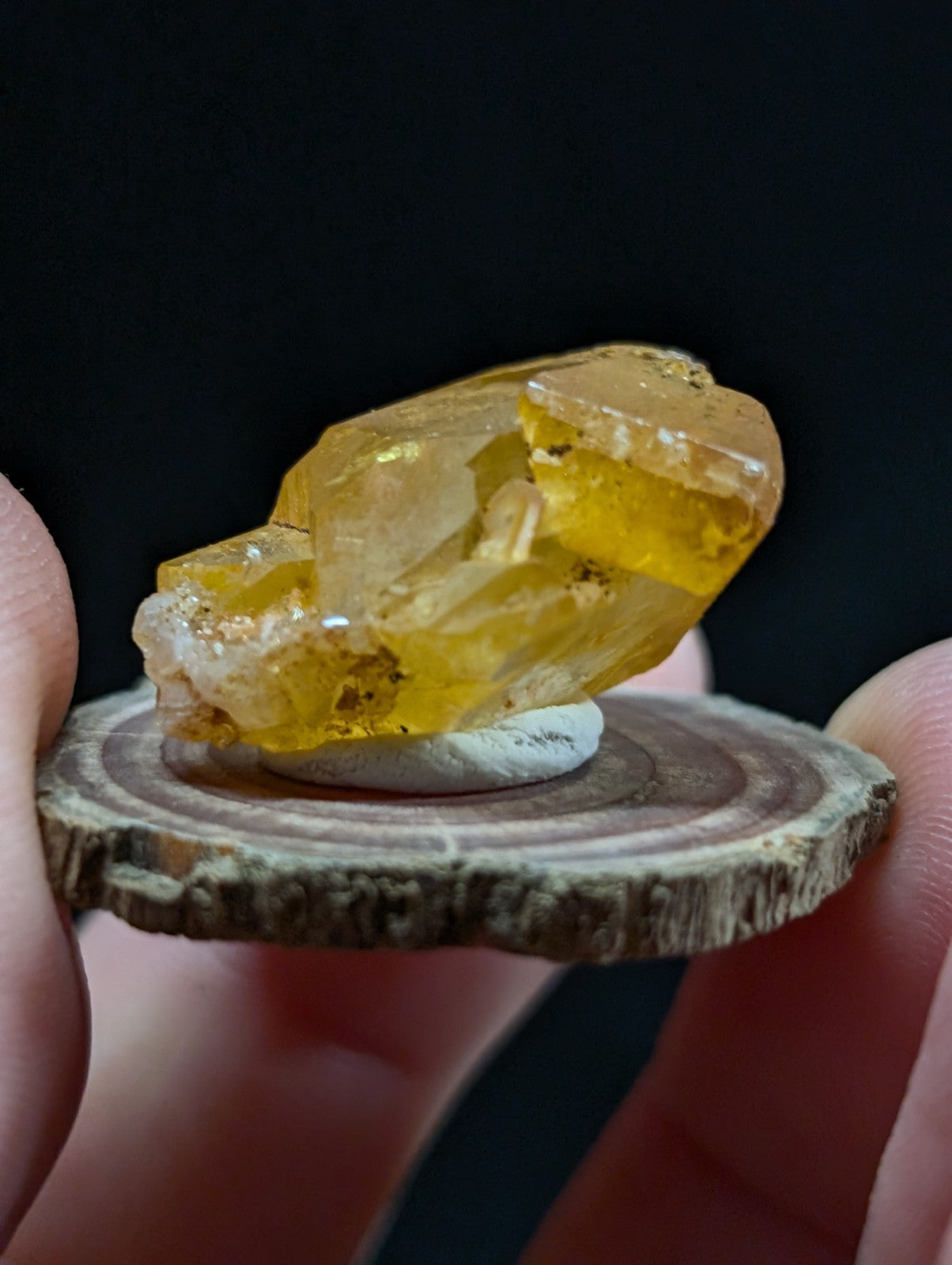 A translucent golden-yellow citrine crystal cluster with a natural, faceted appearance.