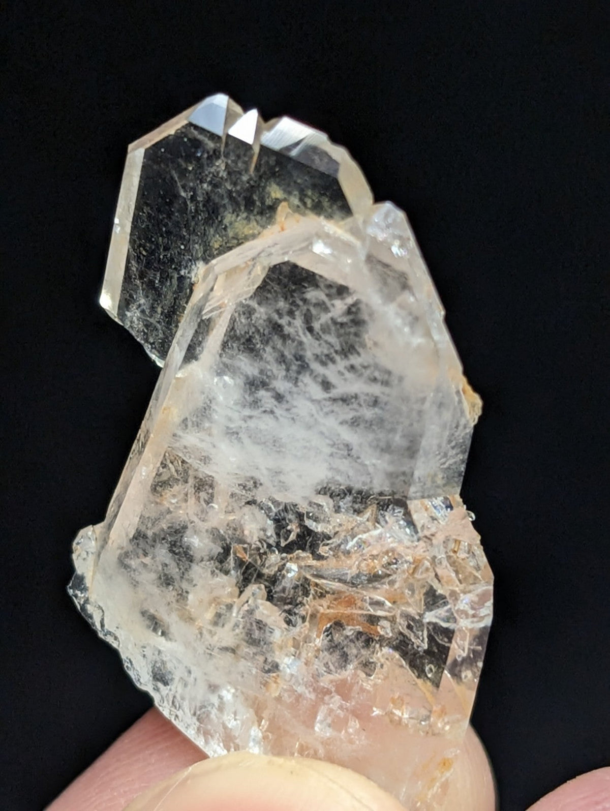 A translucent, multi-faceted quartz crystal cluster with a clear to pale yellowish hue and visible internal inclusions.