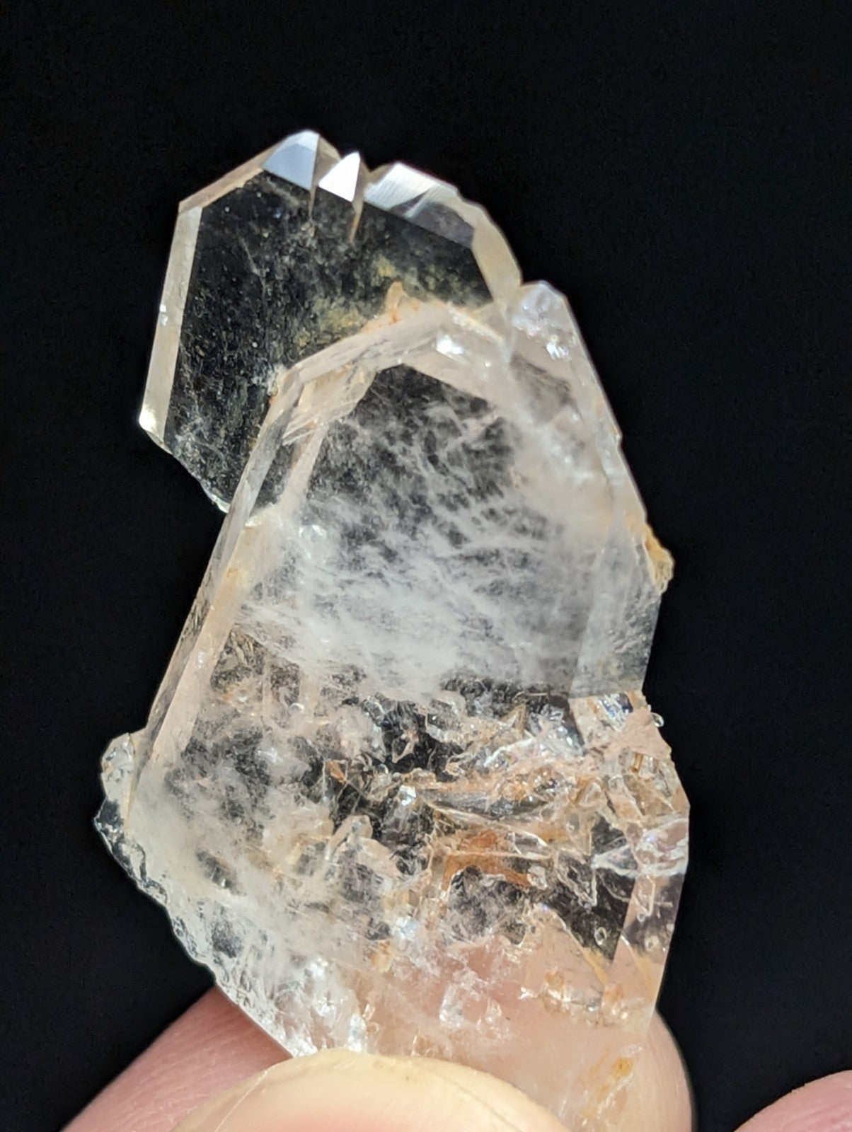 A translucent, multi-faceted quartz crystal cluster with a clear to pale yellowish hue and visible internal inclusions.