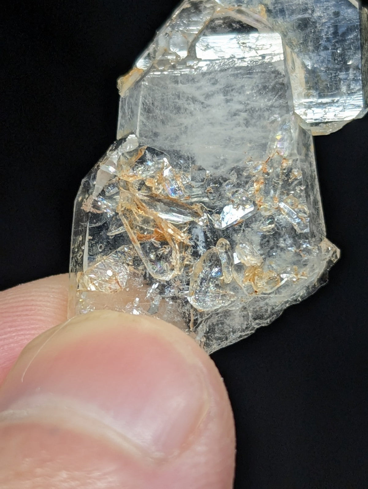 A clear, translucent quartz crystal cluster with subtle golden inclusions and angular facets.