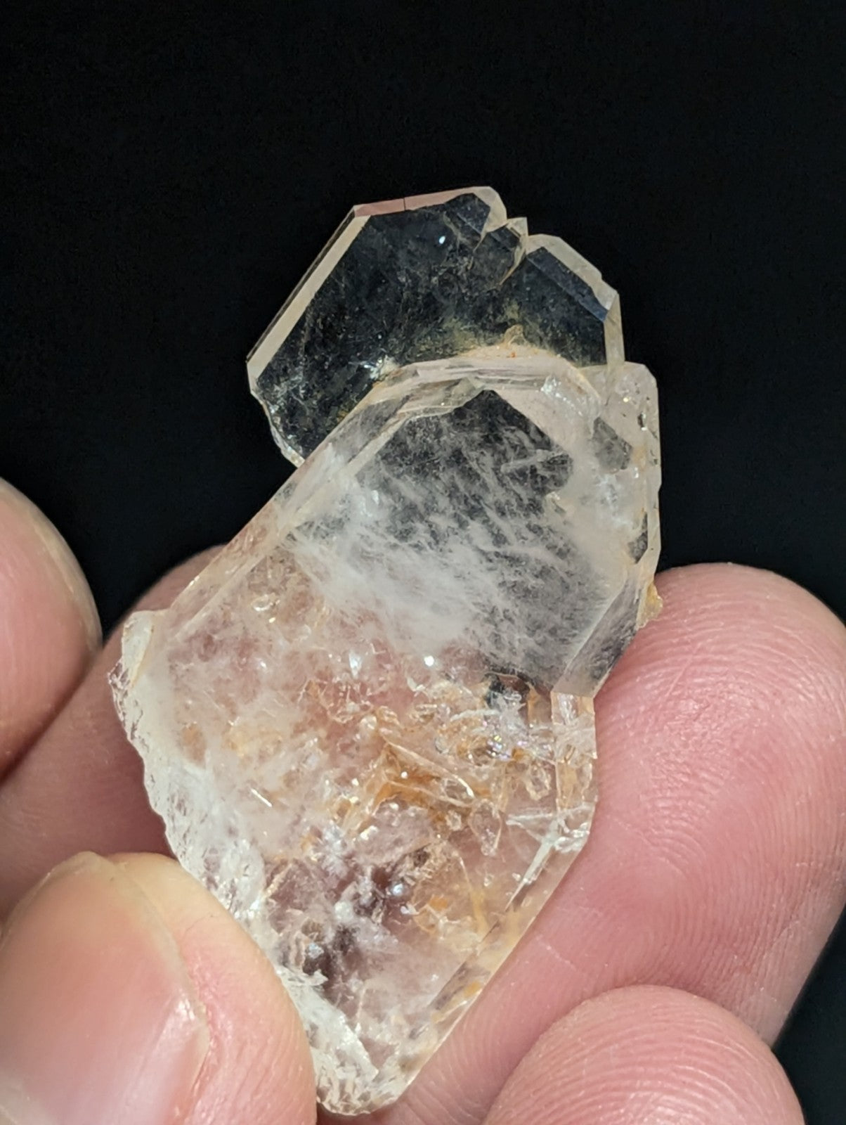 A translucent, faceted quartz crystal cluster with a mix of clear and amber-hued sections.