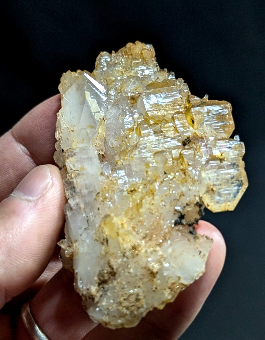 A translucent, crystalline mineral specimen with a mix of clear and golden-yellow hues.