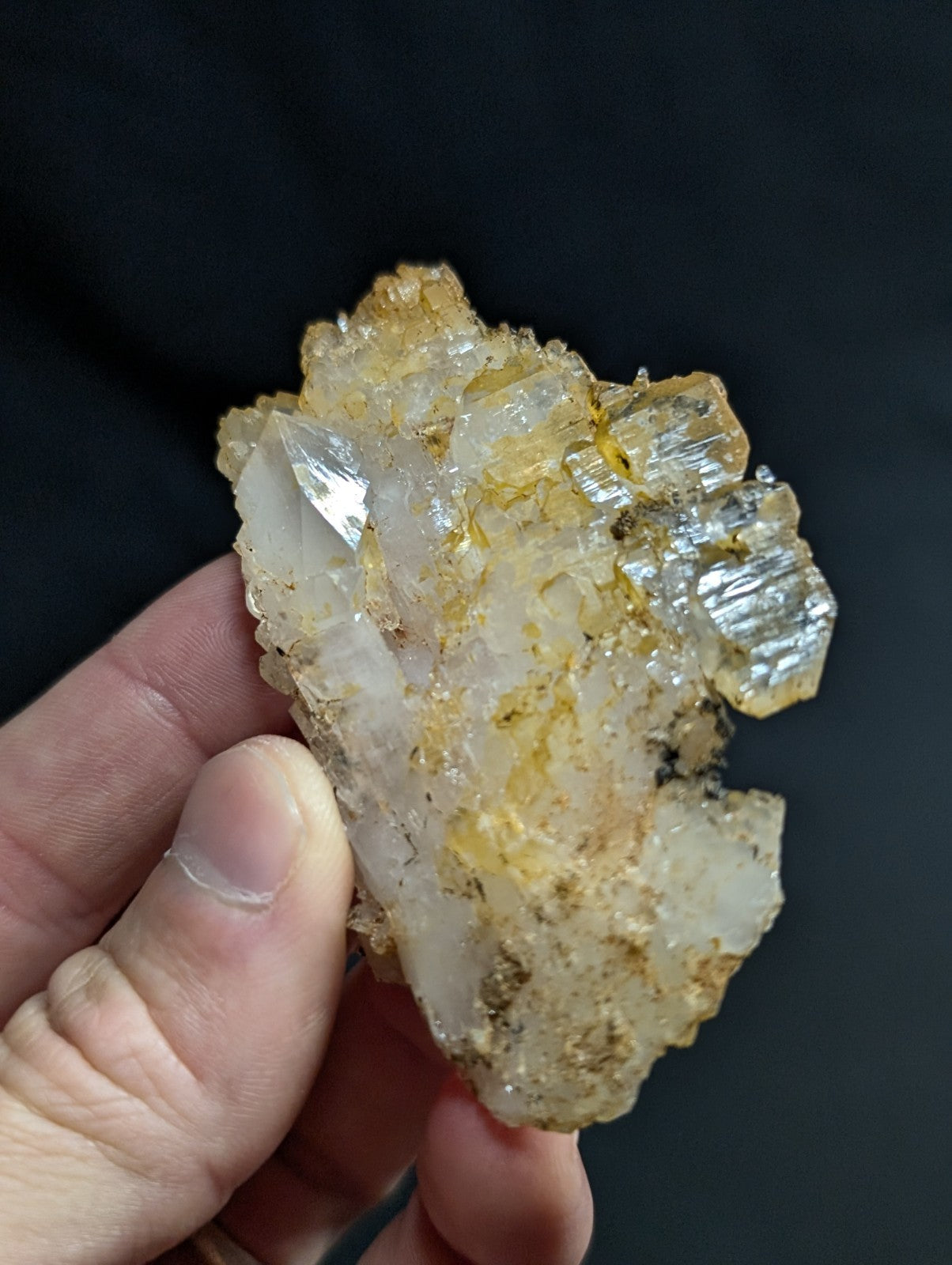 A translucent, crystalline mineral specimen with a mix of clear and golden-yellow hues.