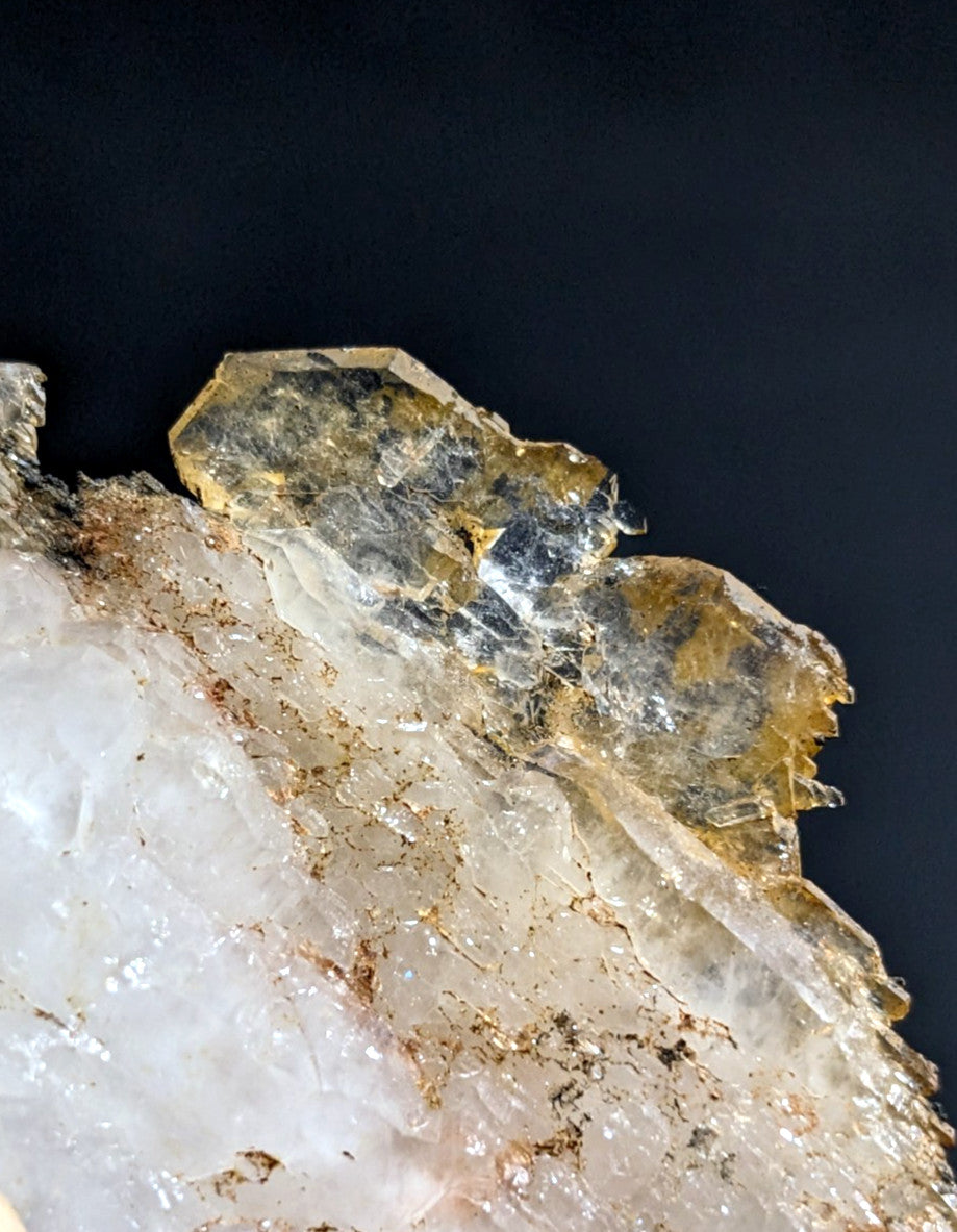 A translucent, crystalline mineral specimen with a mix of clear and golden-yellow hues.