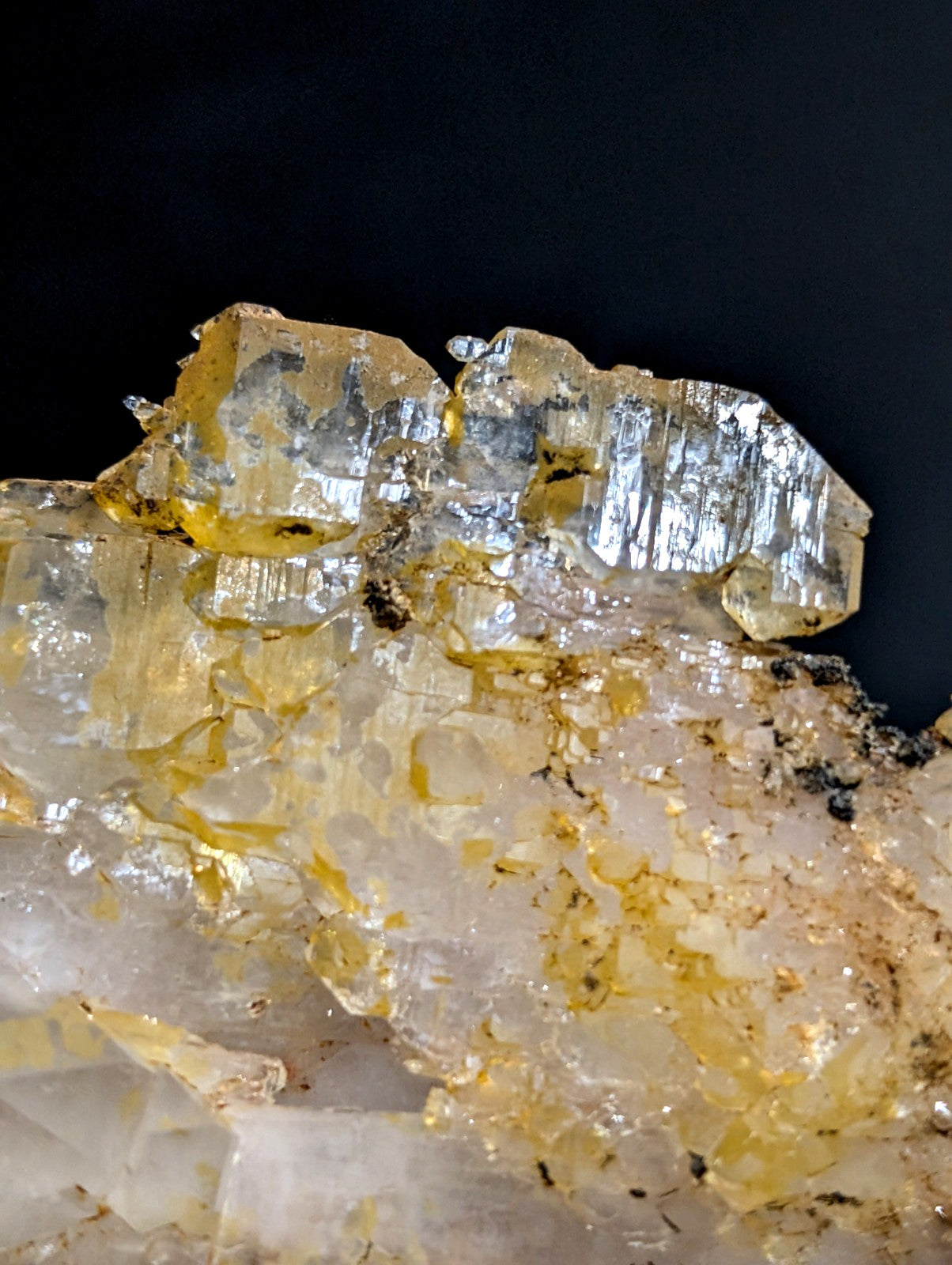 A cluster of translucent yellow and clear quartz crystals with visible striations.