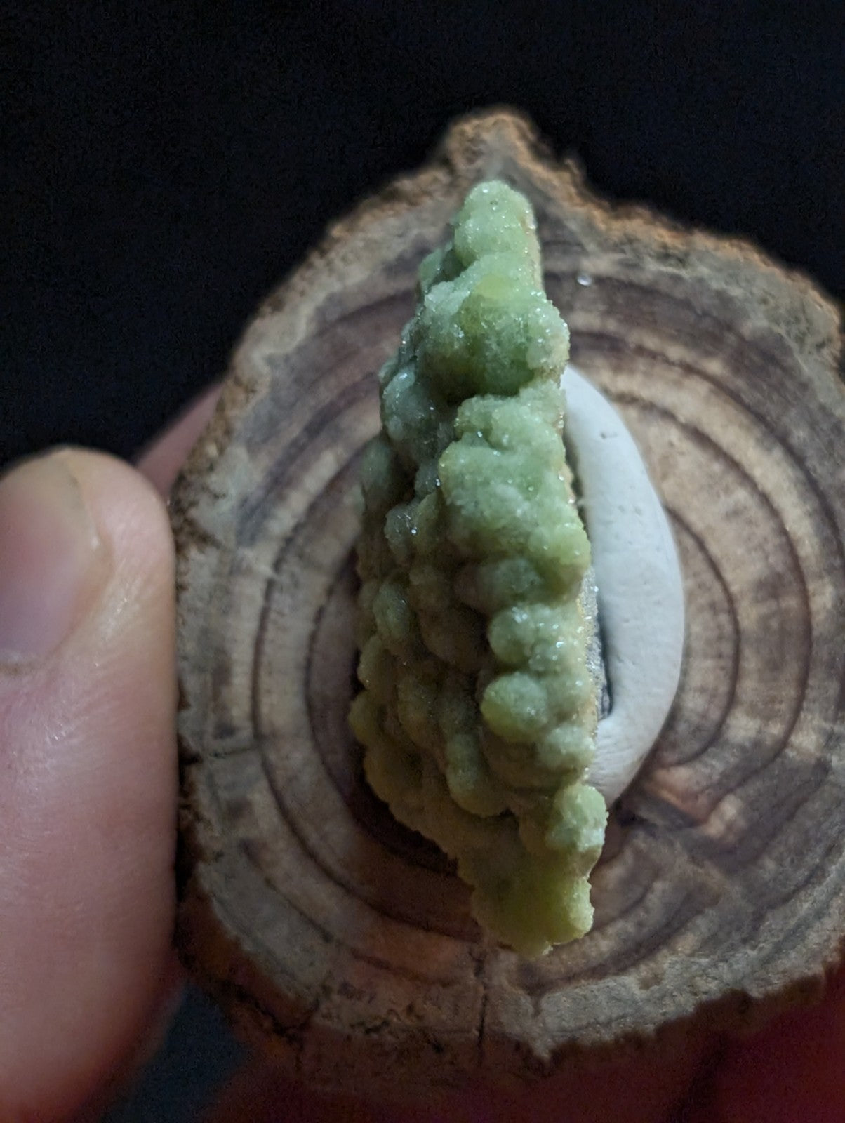 A vibrant green, textured mineral specimen with a crystalline, bubbly surface.