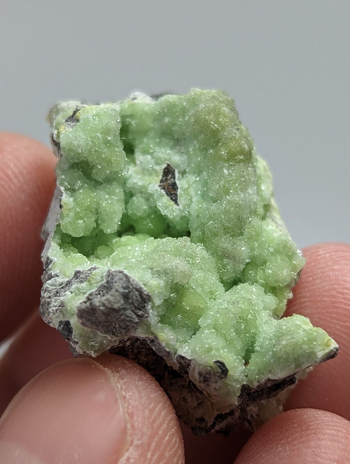 Green crystalline mineral specimen.