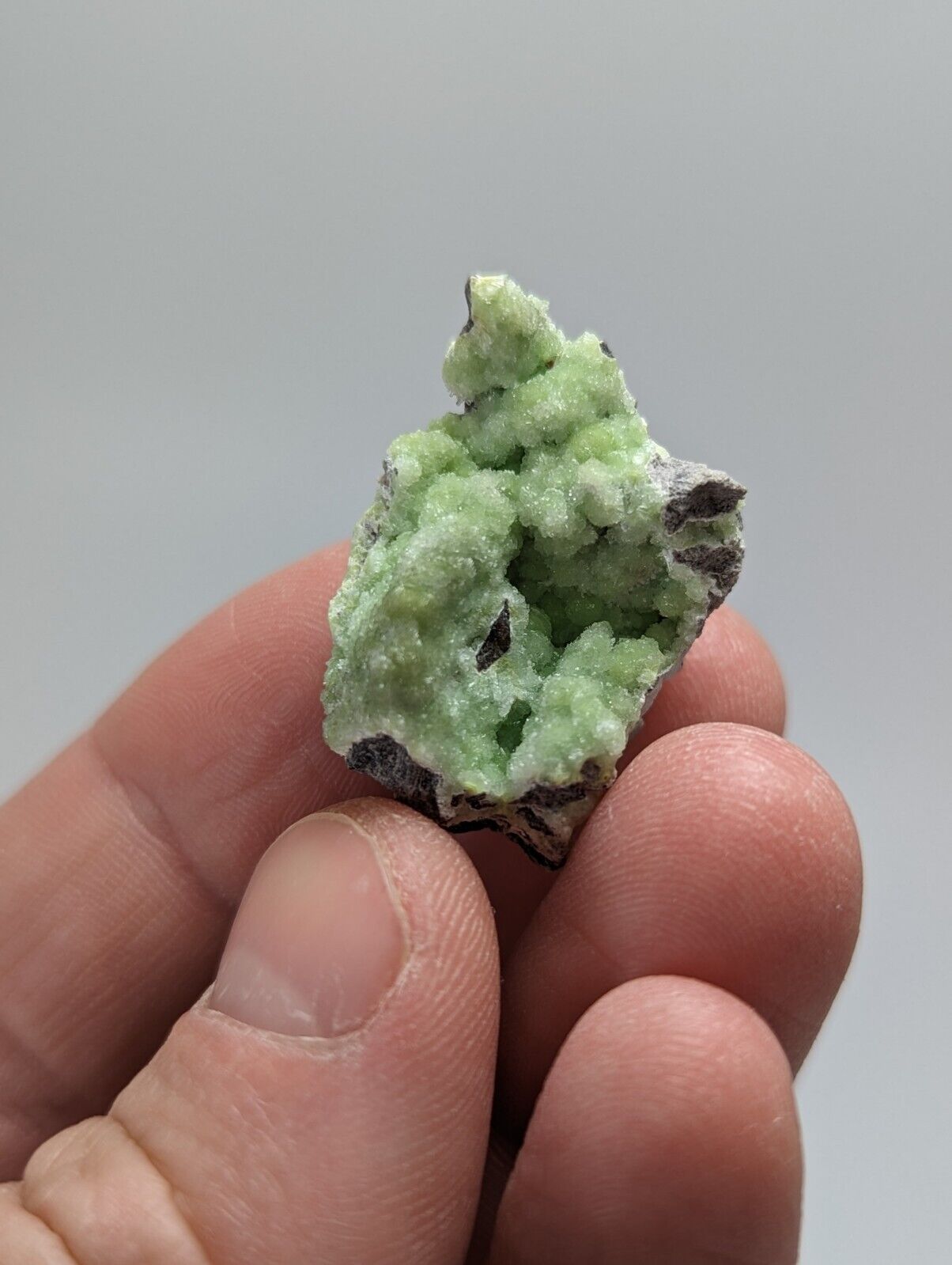 Green crystalline mineral specimen.