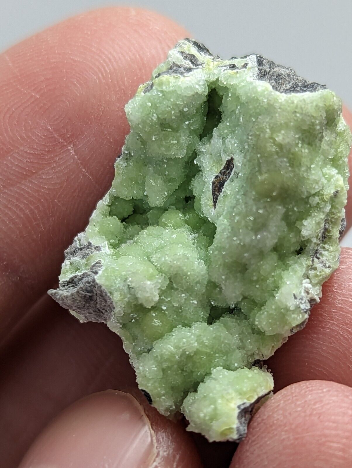 Green crystalline mineral specimen.