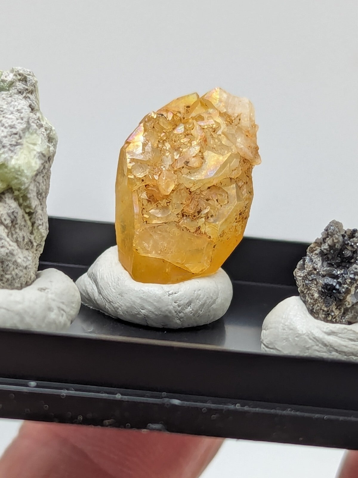 A translucent golden-yellow crystal with a faceted, crystalline structure and embedded darker inclusions.