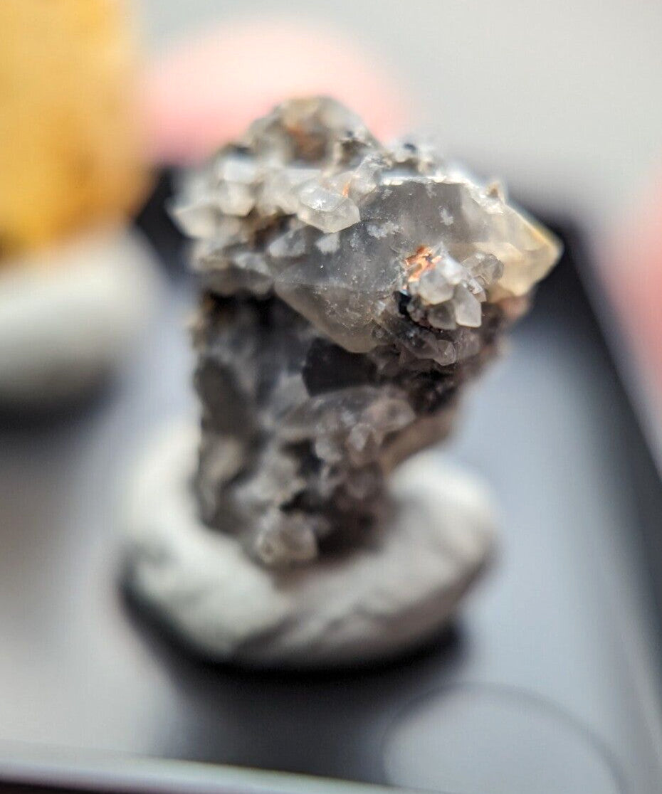 A translucent gray quartz crystal cluster with sharp, faceted points and a rougher base.