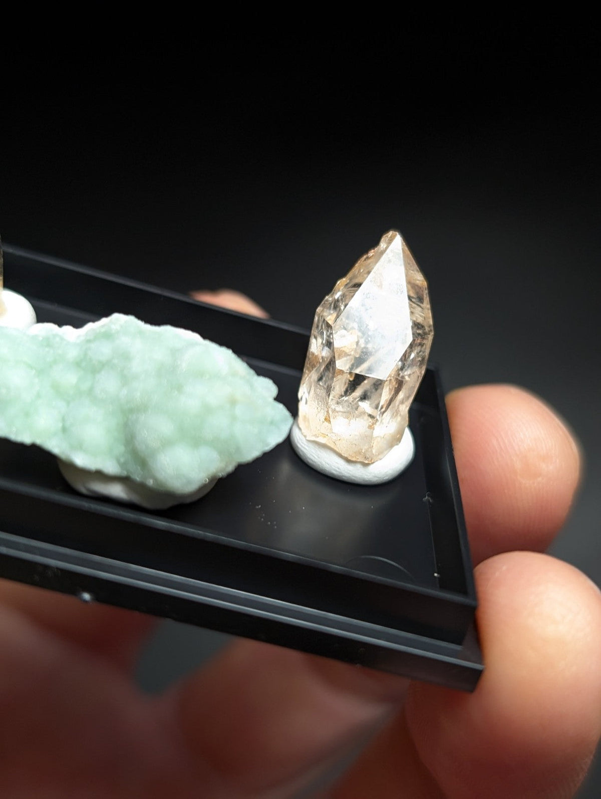 A translucent golden-yellow quartz crystal with a pointed, faceted top and smooth base.