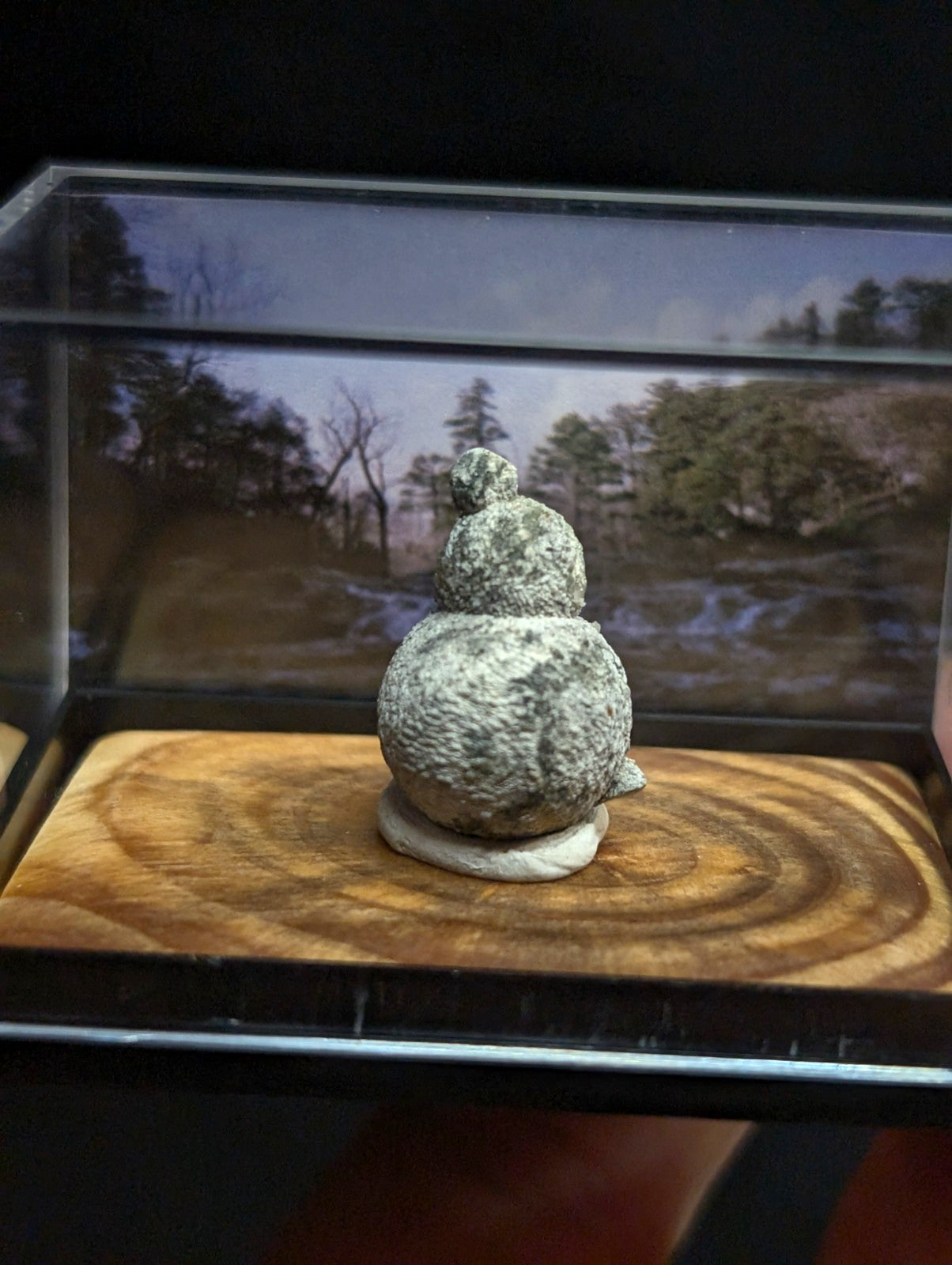 Gray, textured stone figurine shaped like a stacked double-gourd with a small rounded top.
