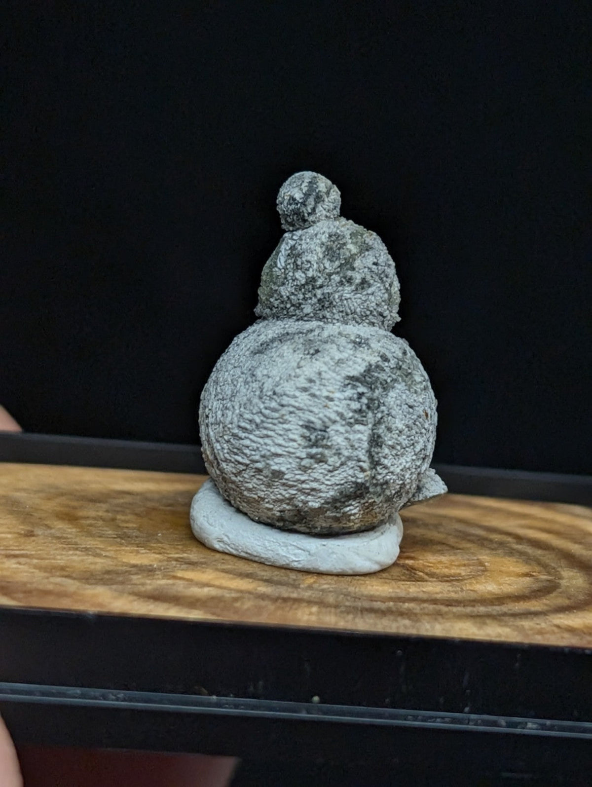 Gray, textured stone figurine shaped like a stacked gourd with a small rounded top.