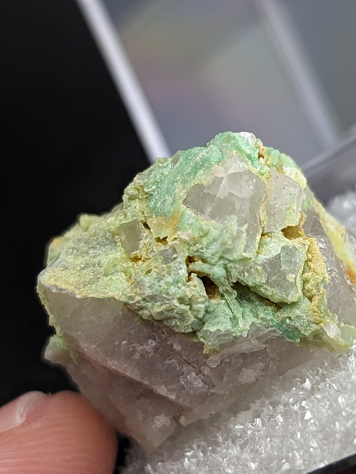 A green and translucent mineral specimen with crystalline formations.