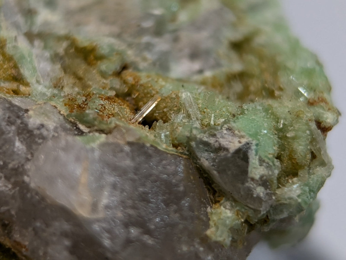Wavellite on variscite mineral with translucent green crystals and earthy brown patches from Polk County Arkansas