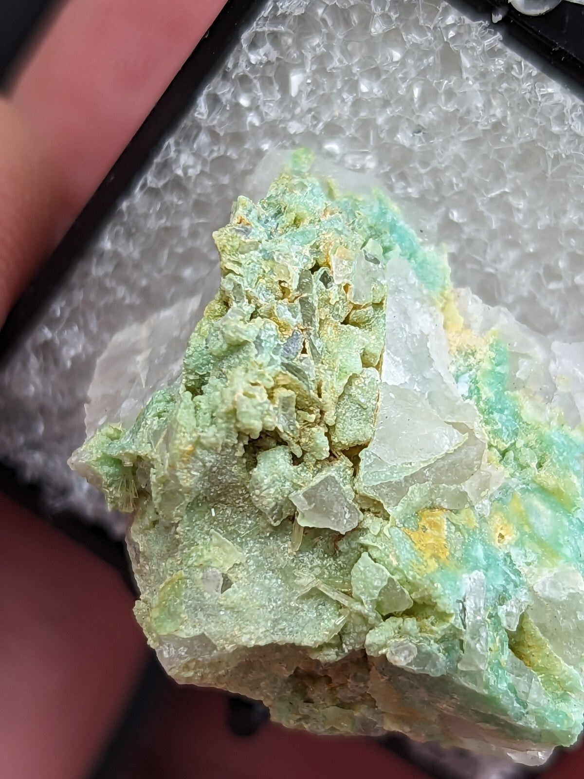 A vibrant green and yellow mineral specimen with translucent crystal formations.