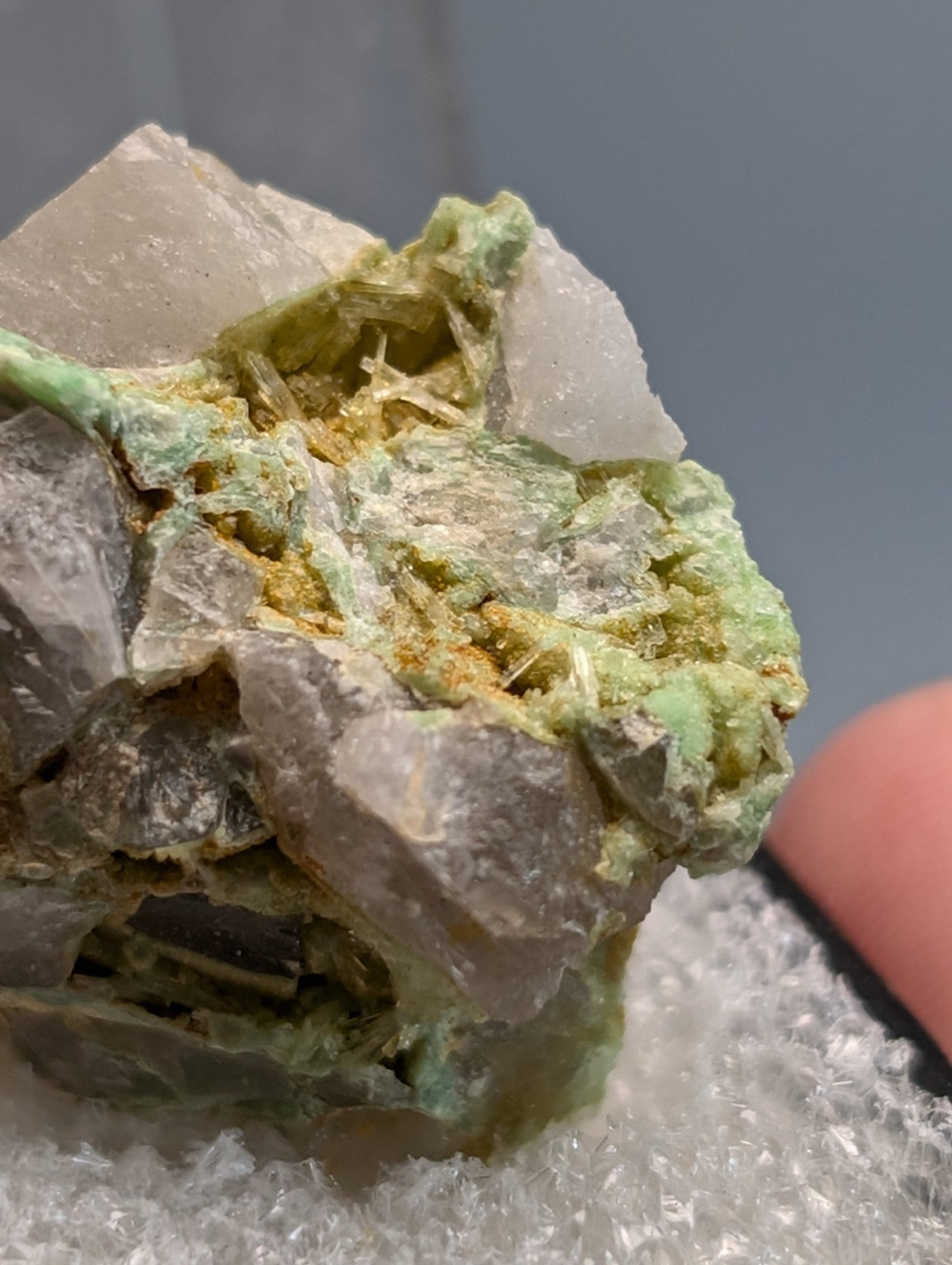 A translucent gray wavellite on variscite rock with green and yellow mineral inclusions from polk county arkansas
