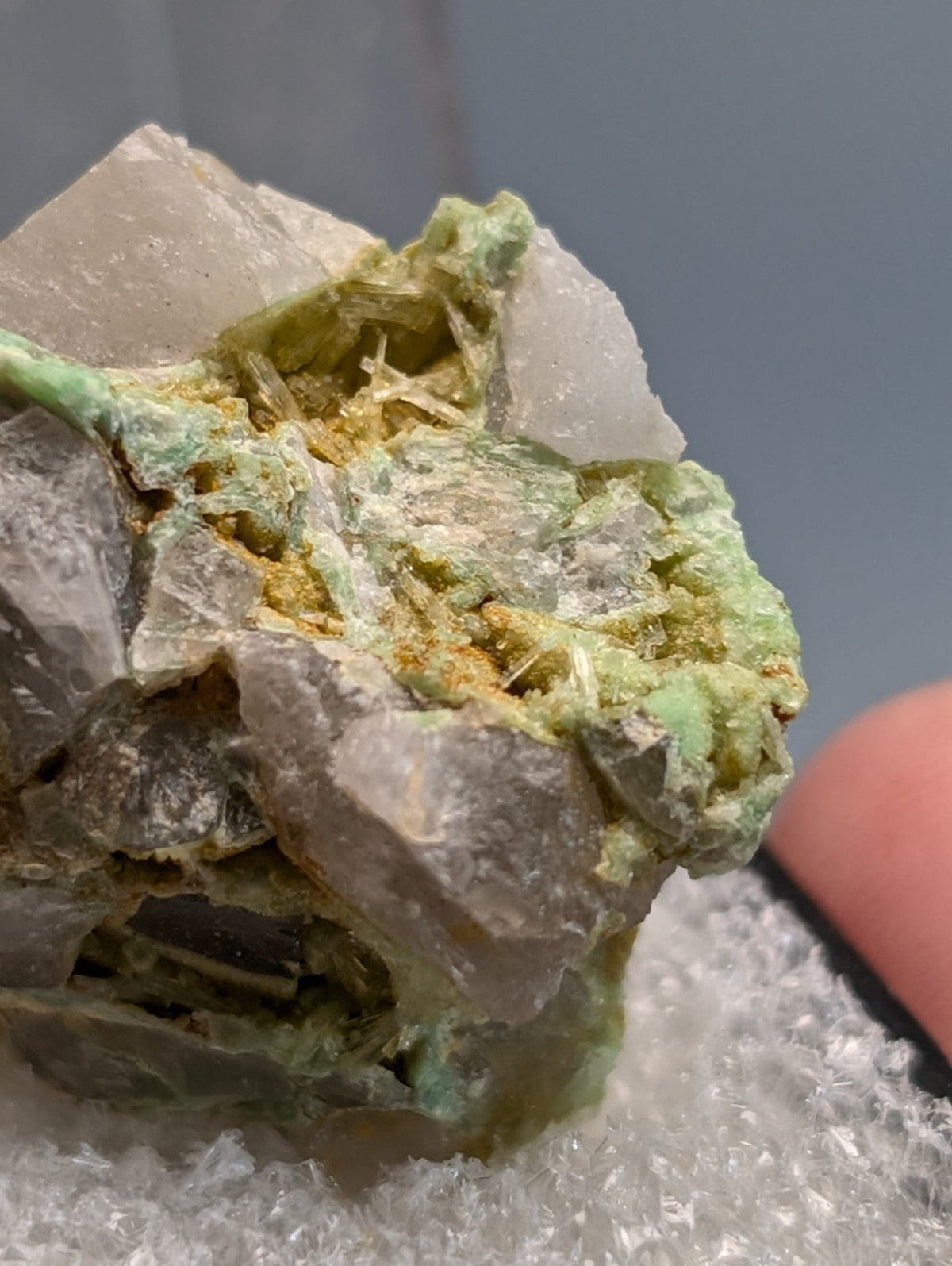 A translucent gray wavellite on variscite rock with green and yellow mineral inclusions from polk county arkansas