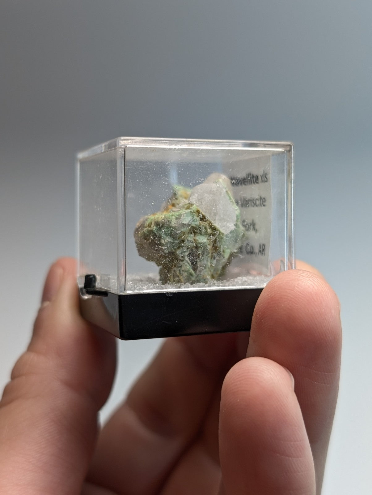 Wavellite on variscite mineral specimen in green and white displayed in clear acrylic case with black base from Arkansas