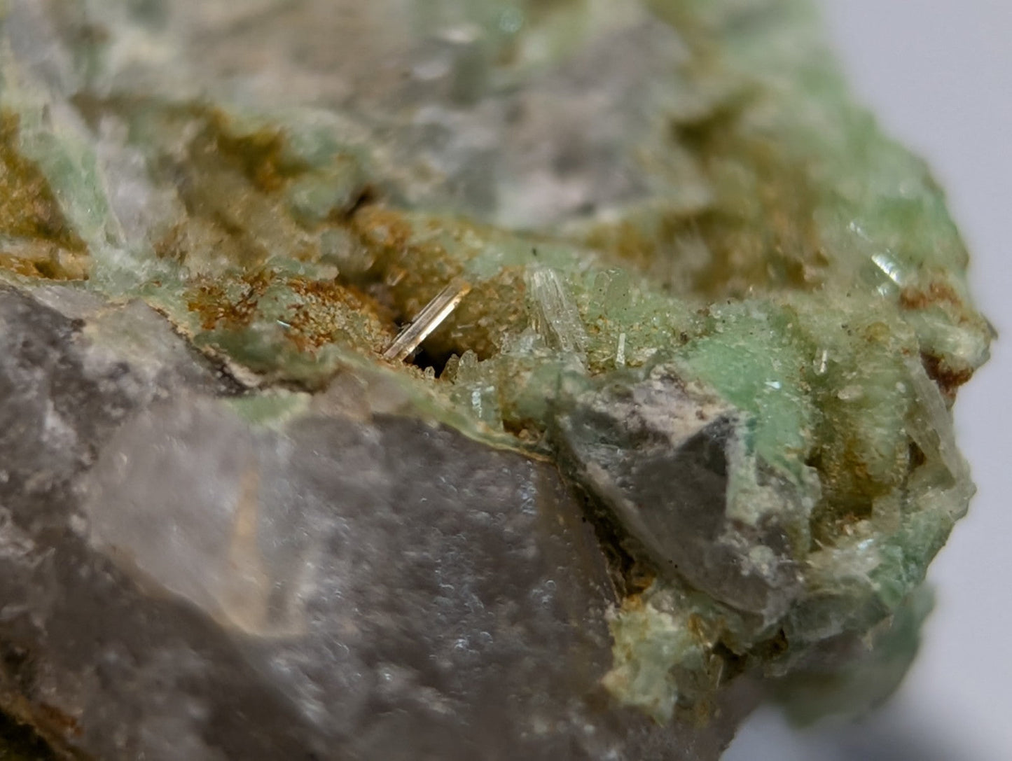 A translucent green wavellite on variscite mineral specimen with crystalline formations and earthy brown patches from arkansas